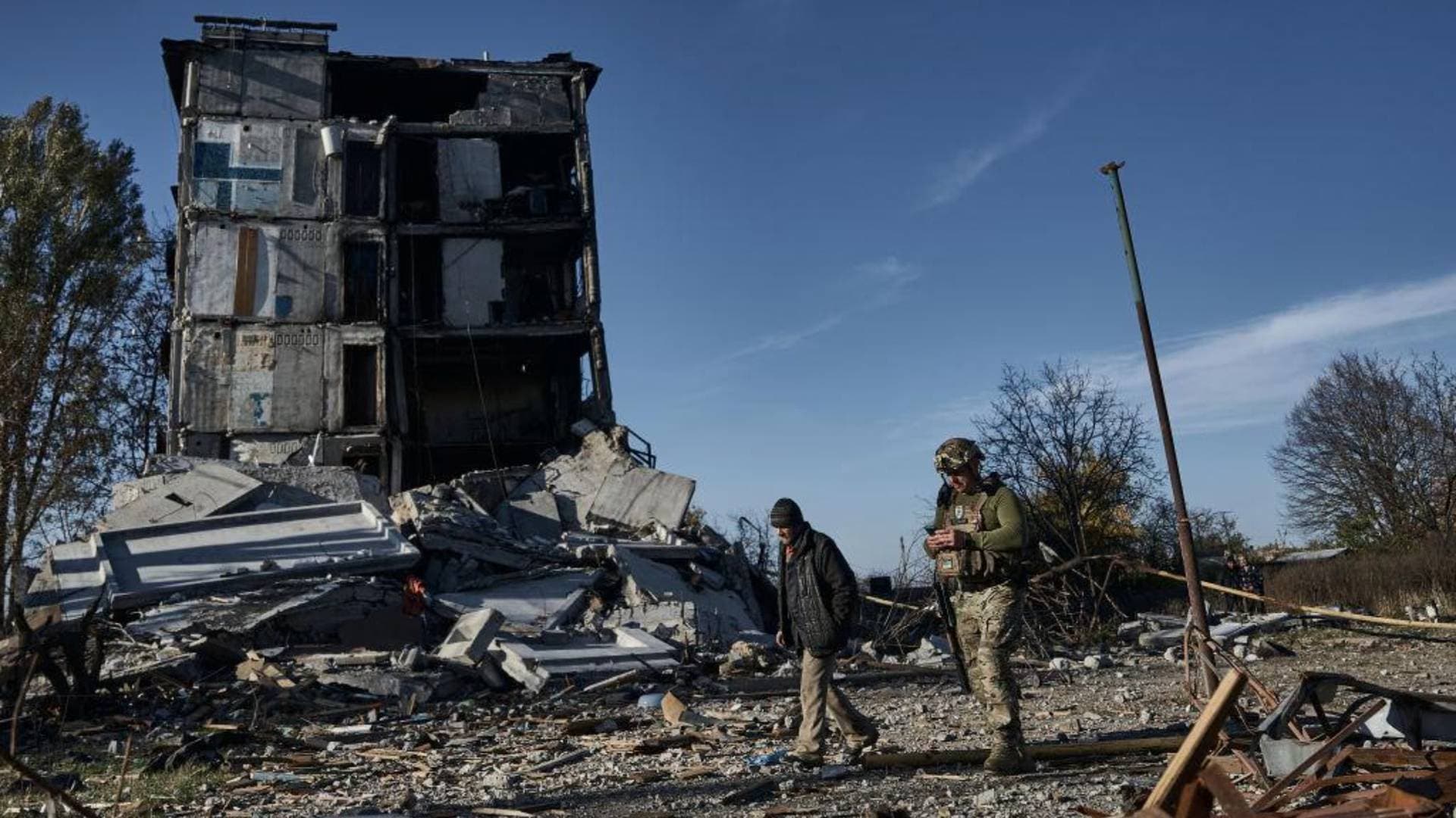 A police officer speaks to a local resident in Avdiivka