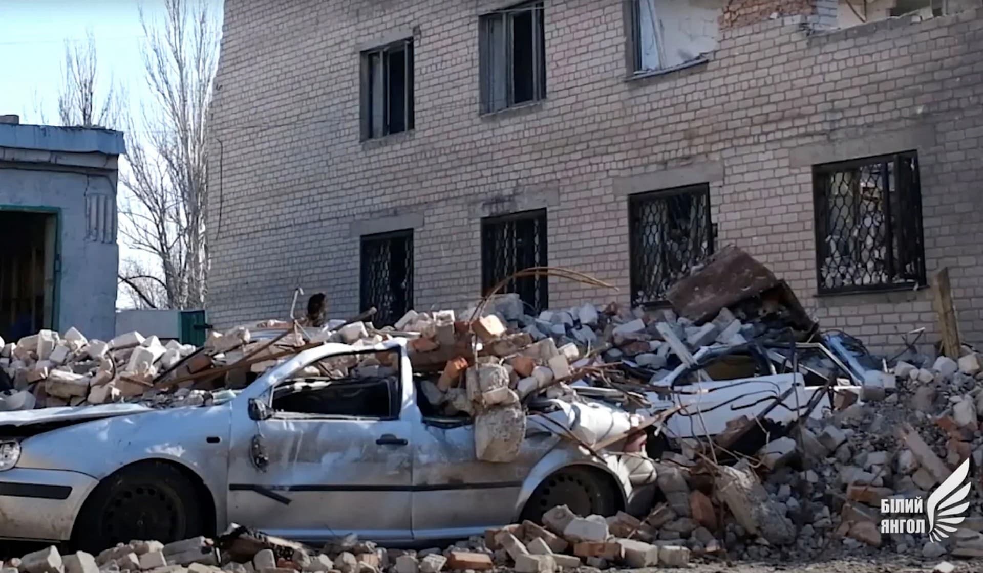 A car damaged by debris in Avdiivka
