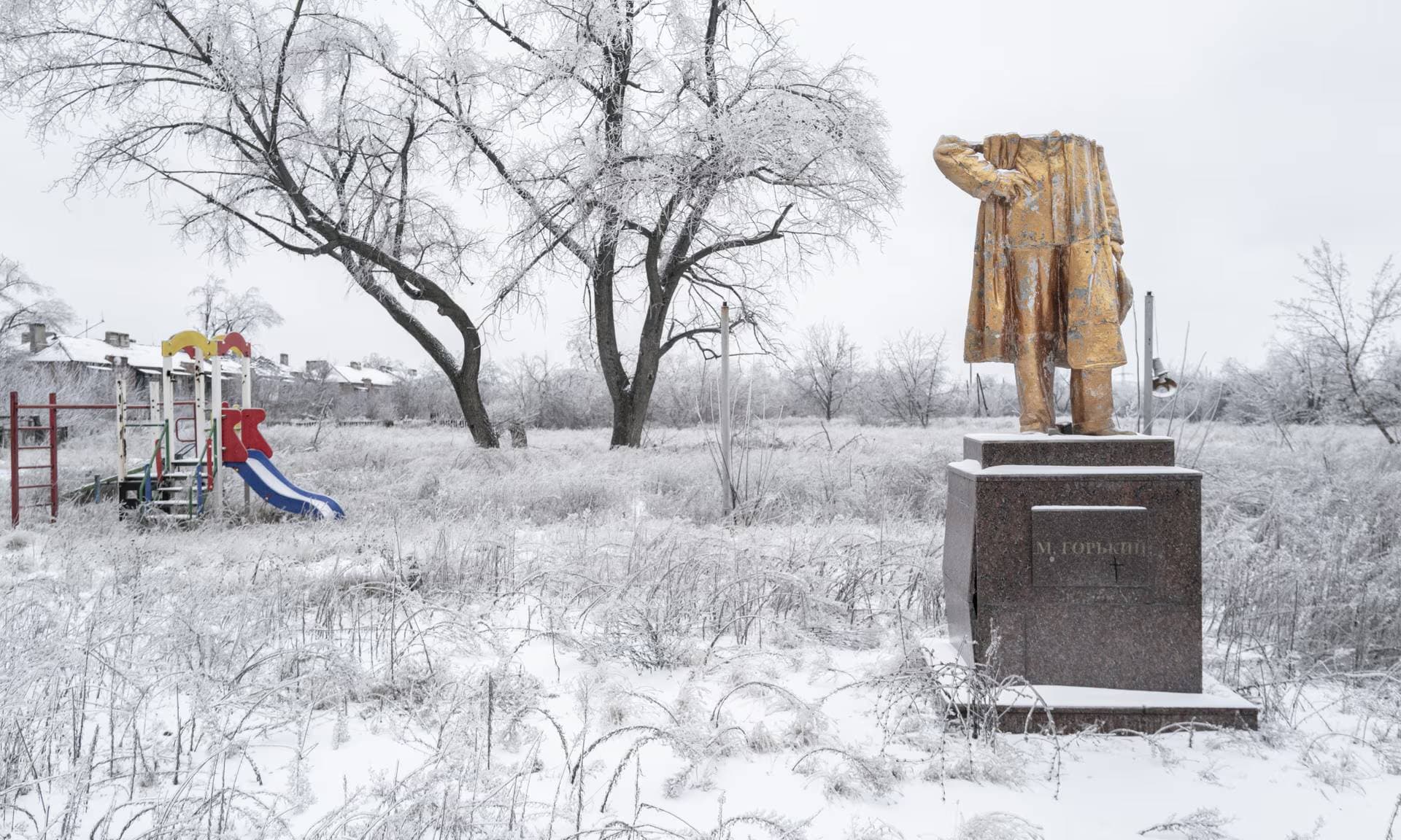 A destroyed monument and a children’s playground in Chasiv Yar