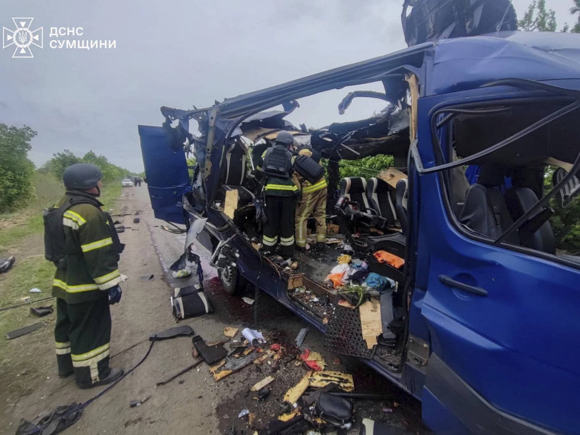 Emergency officers carry out rescue operations after a Russian strike on a van in Bilopillia in Sumy region
