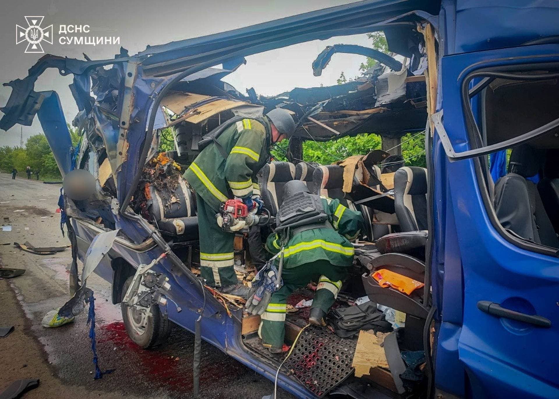 Emergency officers carry out rescue operations after a Russian strike on a van in Bilopillia in Sumy region