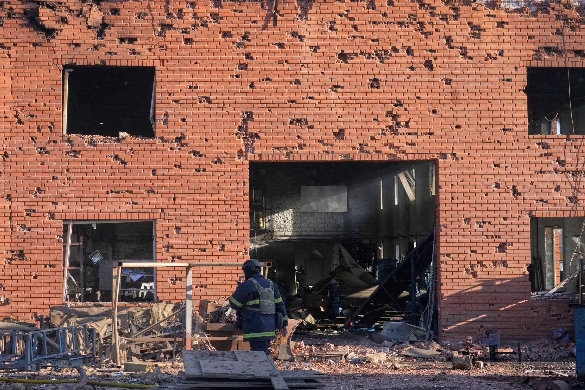 Shrapnel holes cover the wall of the damaged railway workshops, following a Russia missile and drone attack, in Brovary
