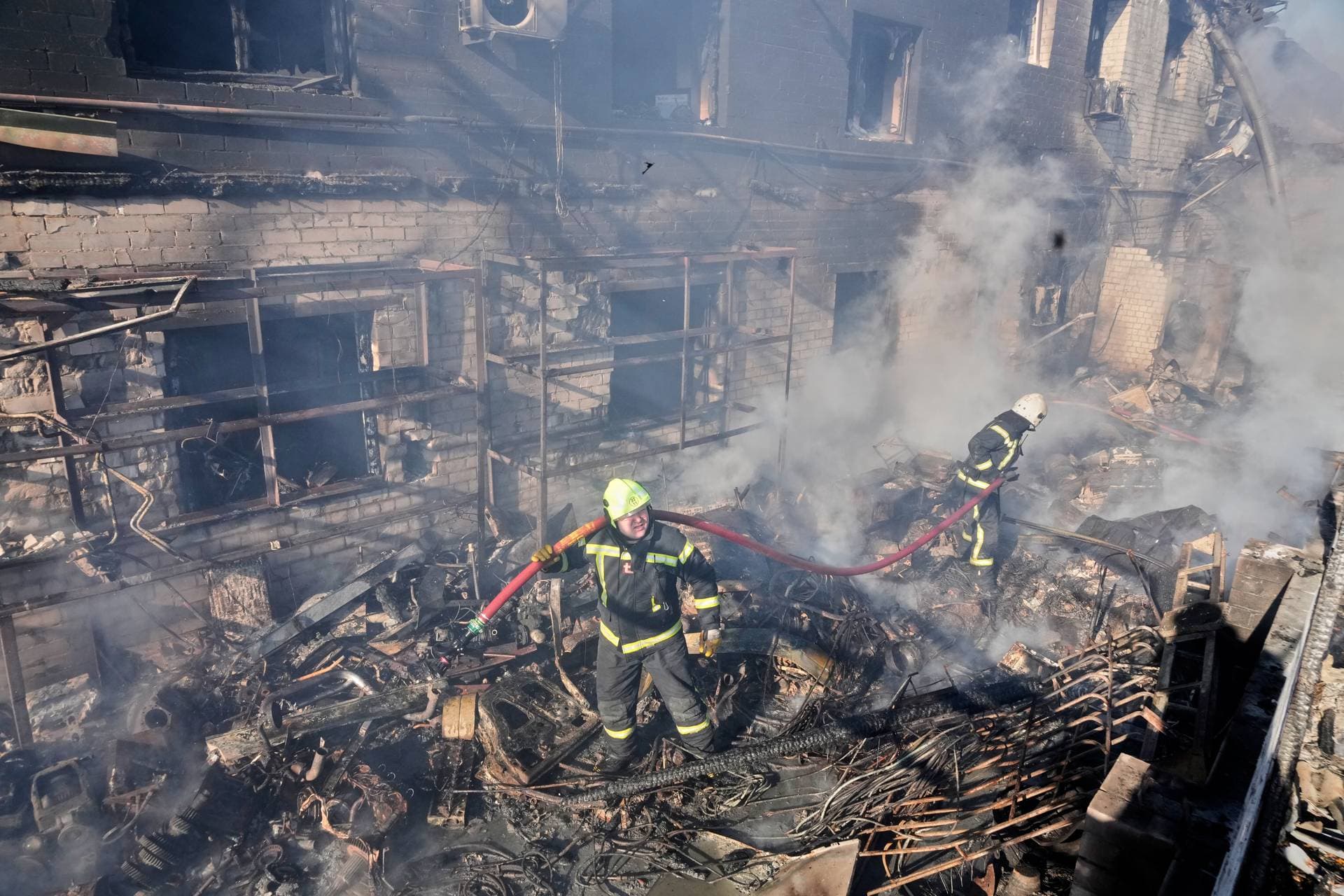 Firefighters put out the fire in a residential neighborhood following a Russian missile and drone attack, in Brovary