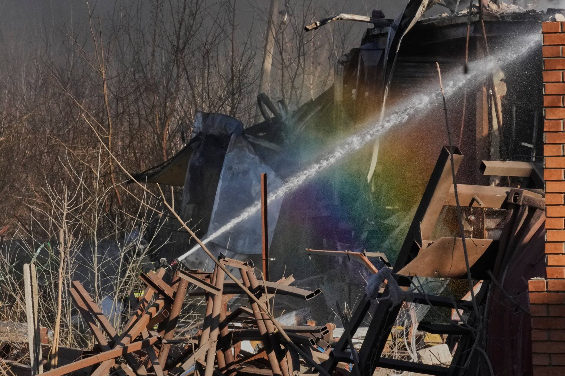 Firefighters put out the fire at railway workshops following a Russia missile and drone attack, in Brovary