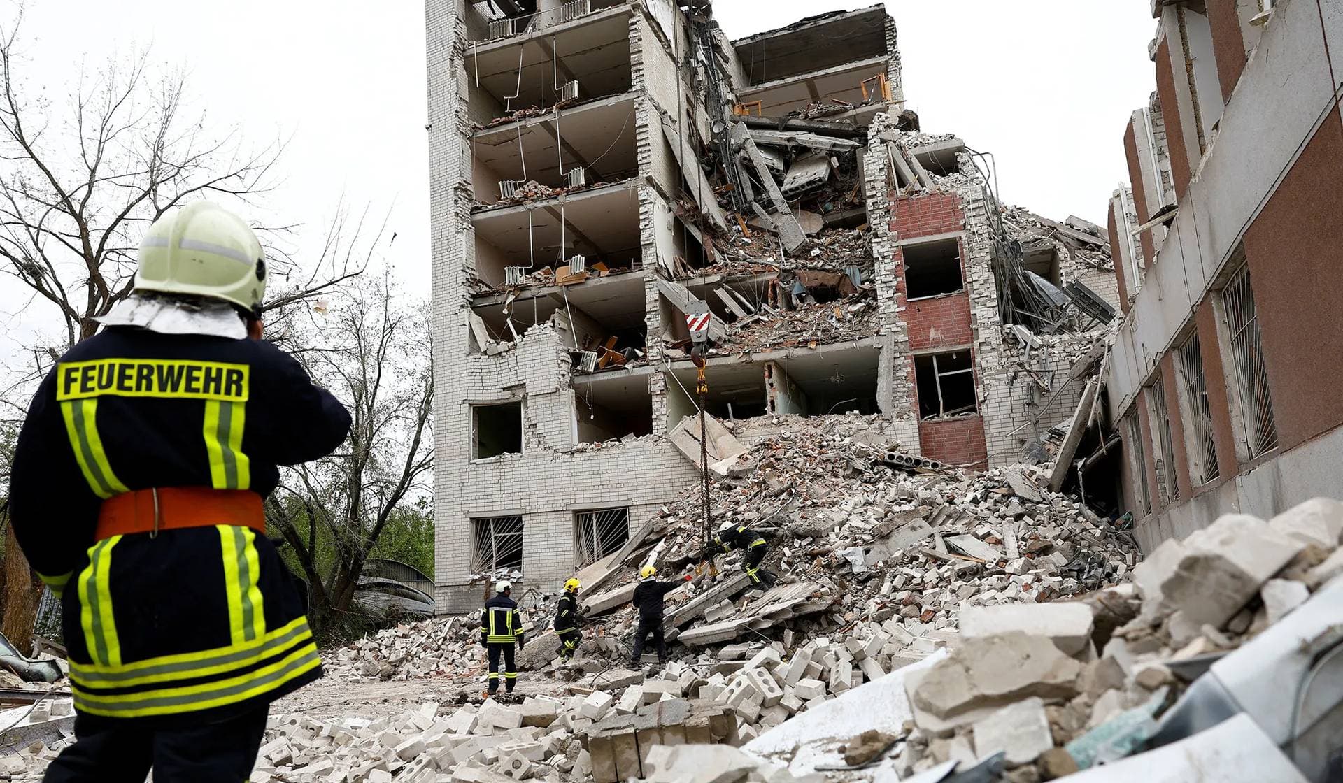 Rescuers work at the site of a destroyed building during a Russian missile strike in Chernihiv