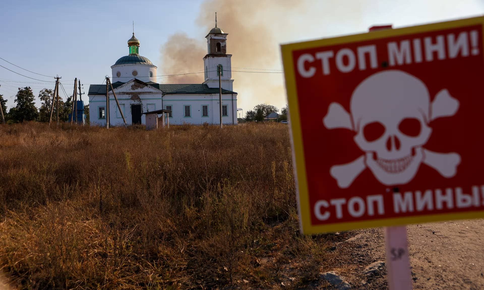 A fire burns in mined fields and forest strips near the village of Grakovo