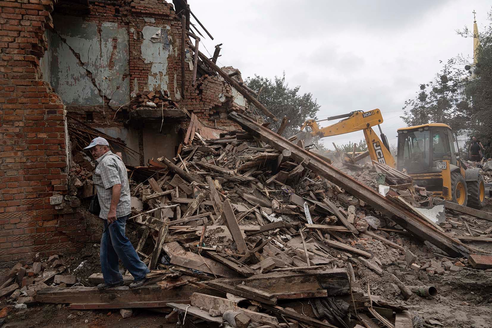A local man stands in front of his destroyed house after Russian shelling in a residential area in Chuhuiv