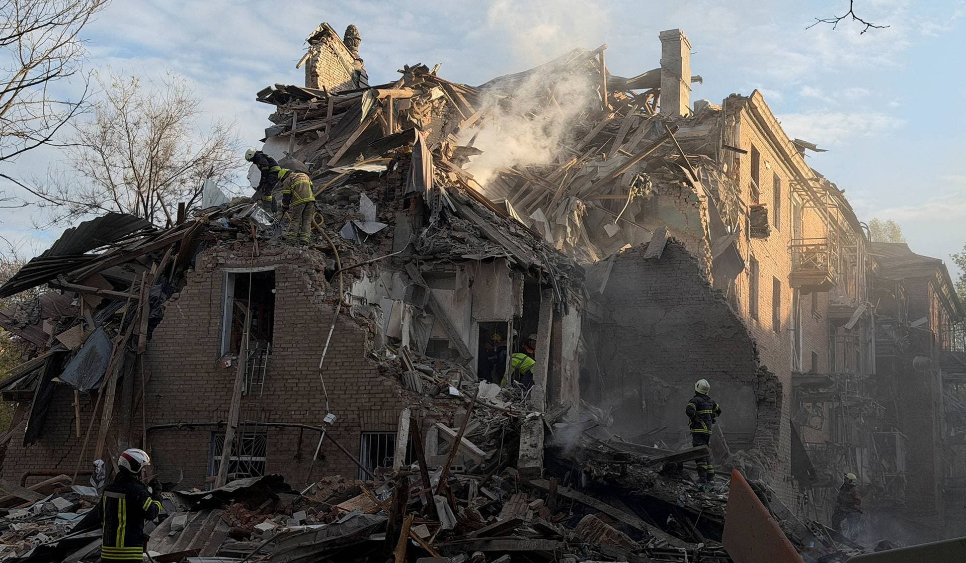 Rescuers work at the site of an apartment building hit by a Russian drone and missile strike in Dnipro