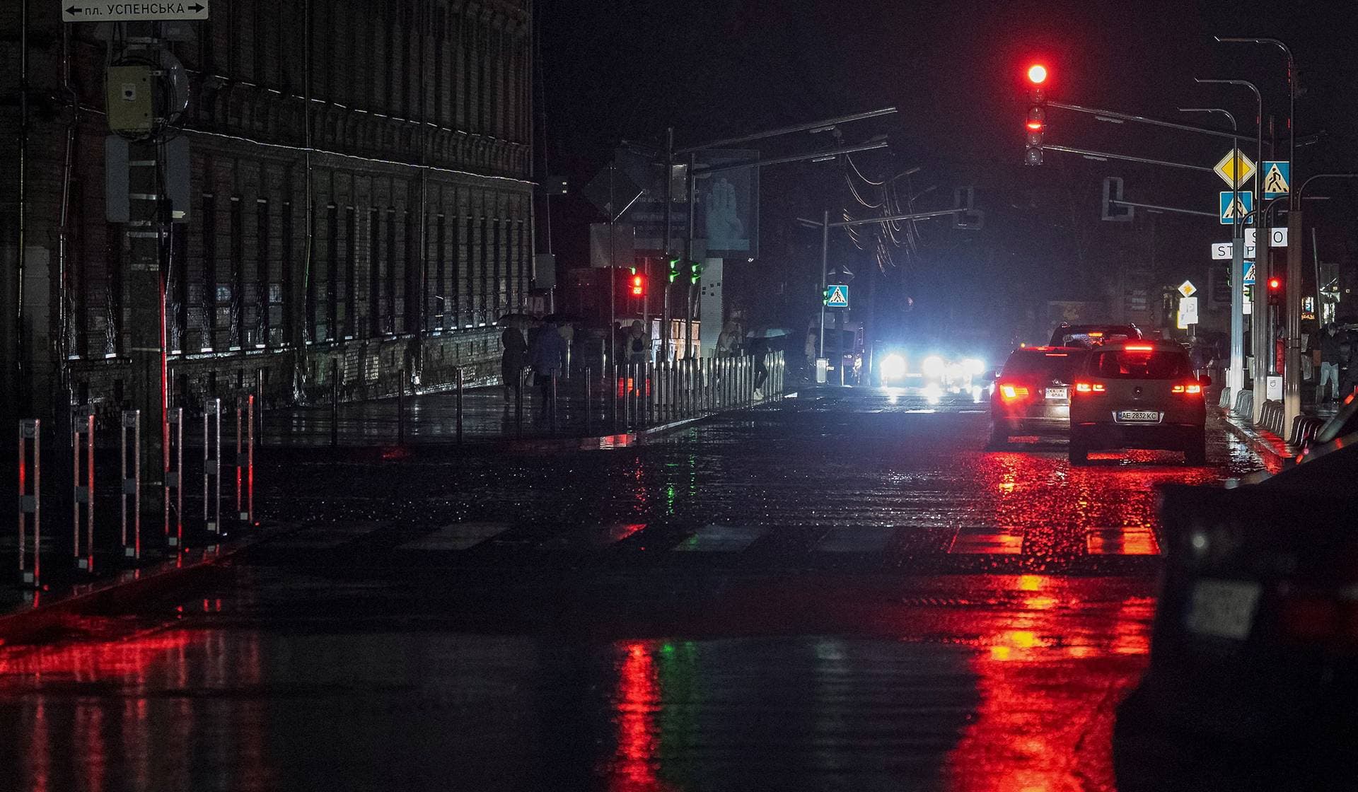 Cars drive on a street during a power blackout after critical civil infrastructure was hit by recent Russian missile and drone attacks in Dnipro