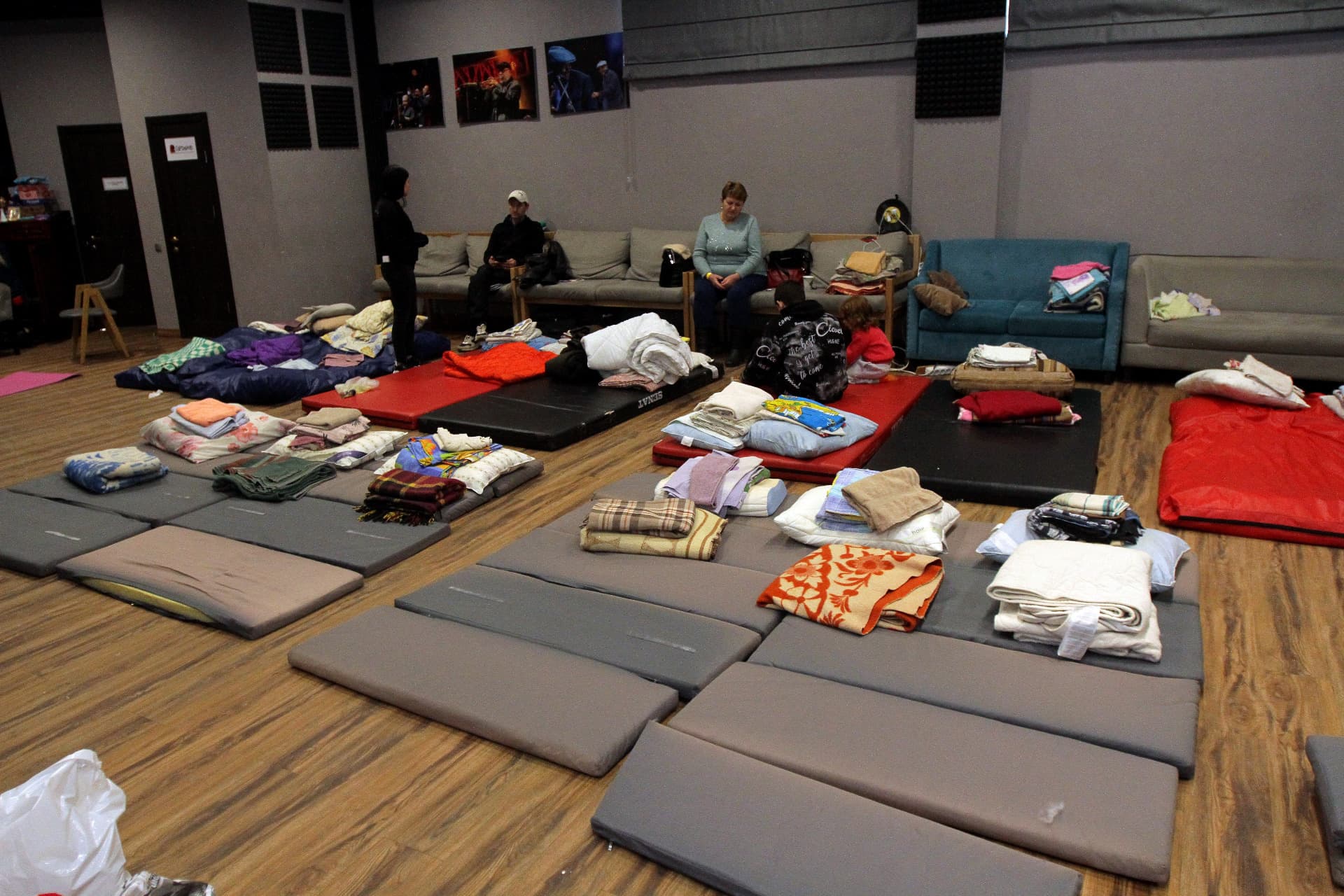 People stay in a shelter after the first civil defence siren goes off in Dnipro, central Ukraine