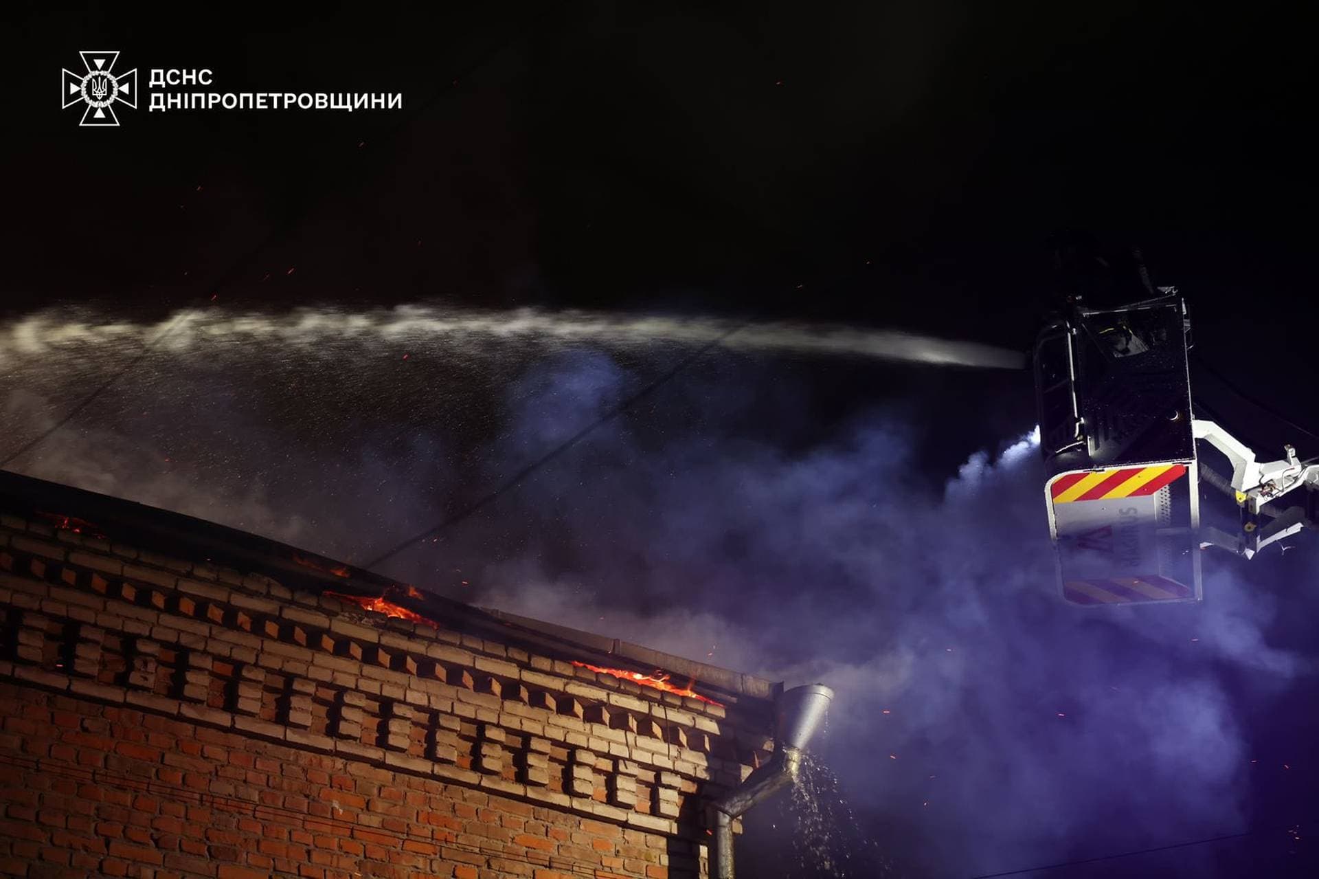 A firefighter works at the site of a Russian drone strike in Dnipro