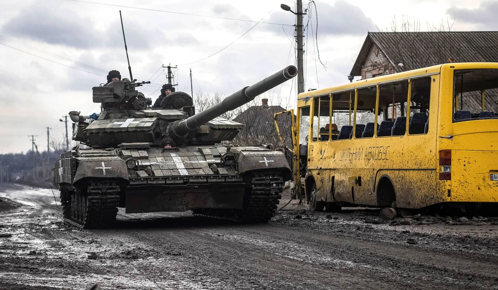Ukrainian servicemen ride a tank in the village of Torske