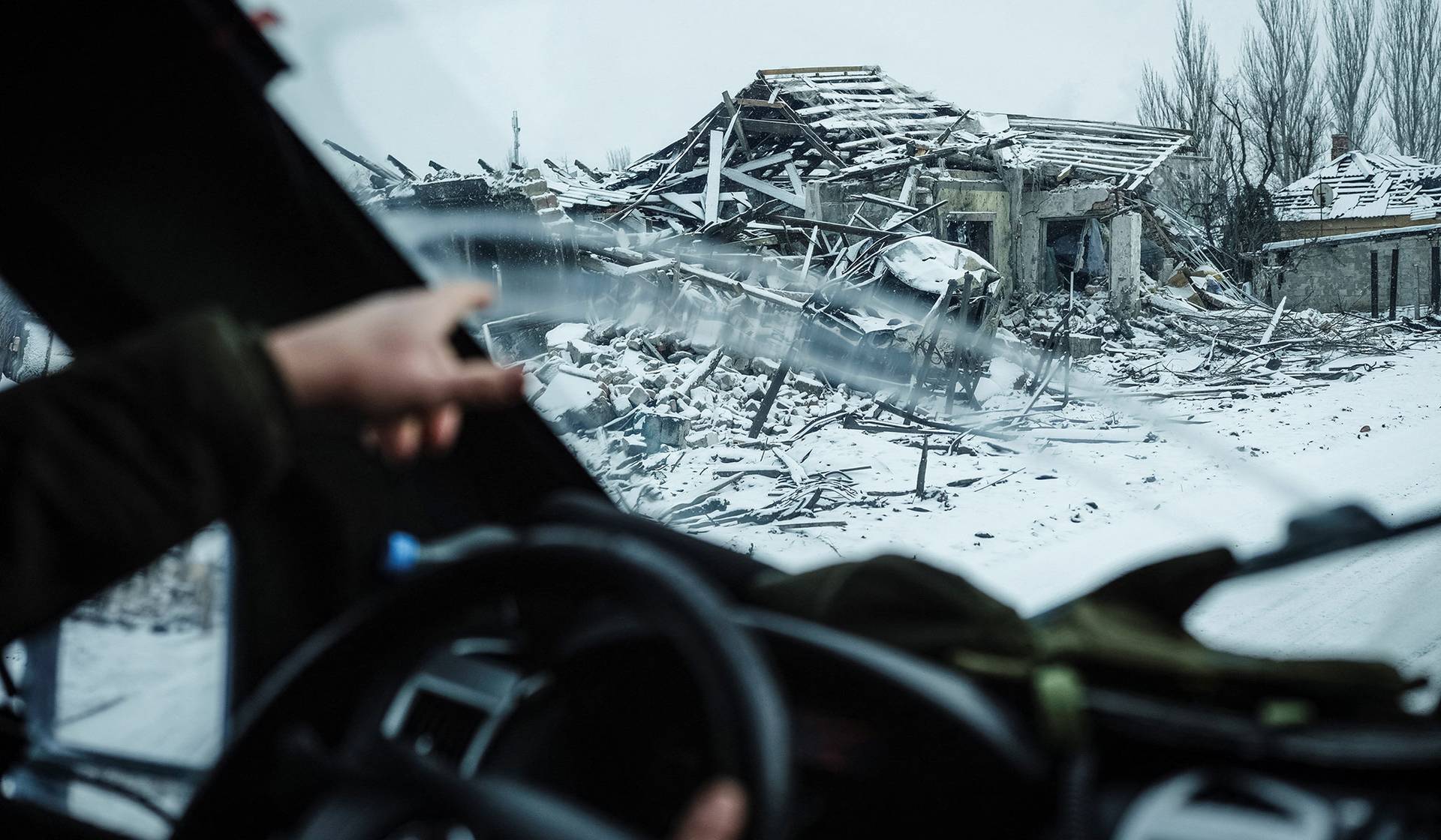 A member of the White Angels police evacuation unit rides in an armored vehicle during an evacuation from the town of Druzhkivka