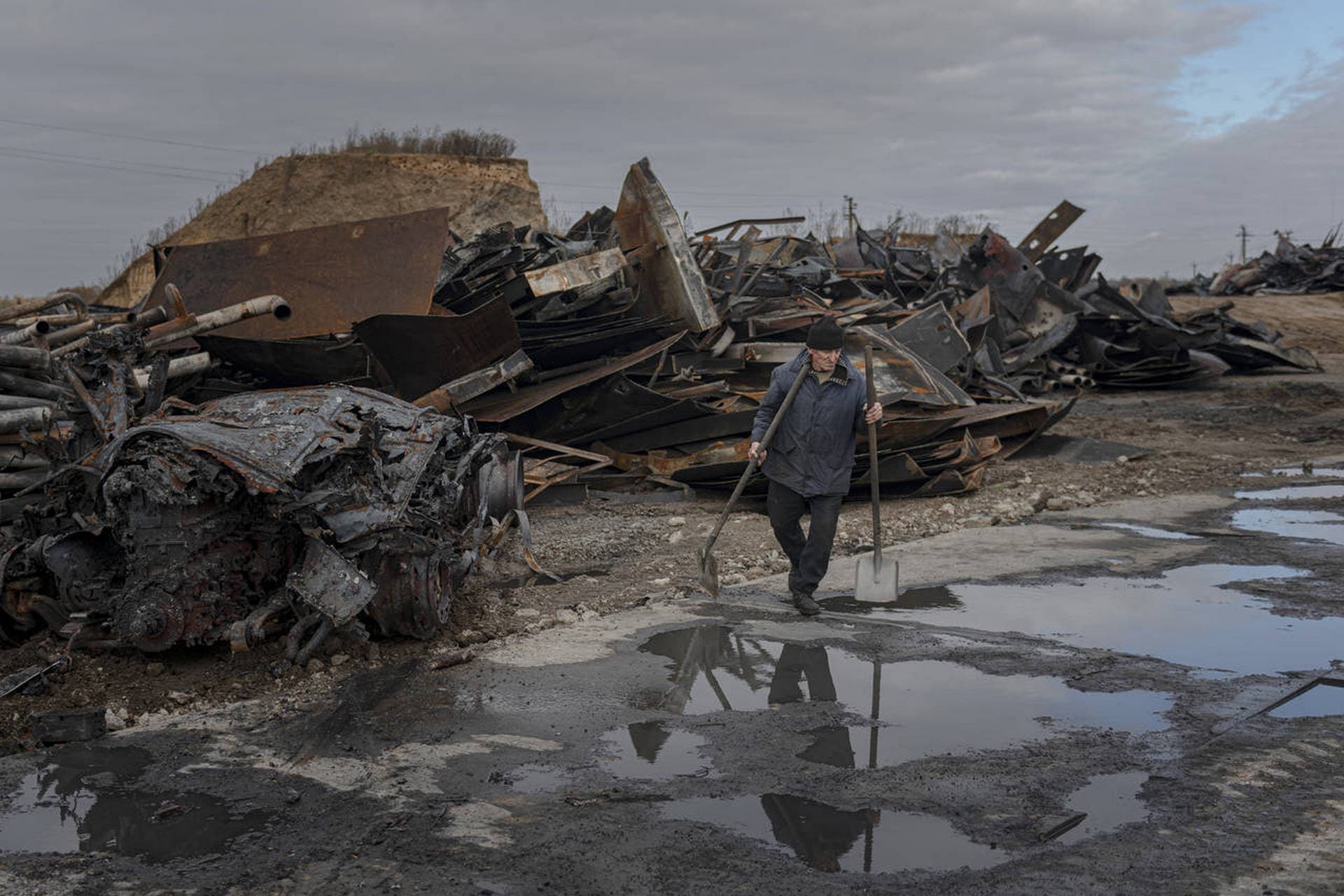 A worker walks at a fuel depot hit by Russian missile in the town of Kalynivka