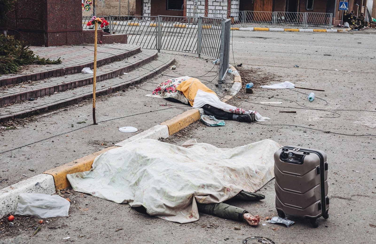 The dead bodies of civilians killed while trying to flee are covered by sheets in Irpin on March 6