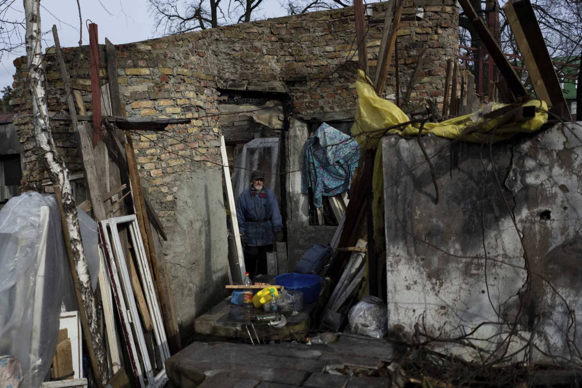 Oleh Mnozhynska, 82, stands in his house destroyed by an airstrike, in Irpin
