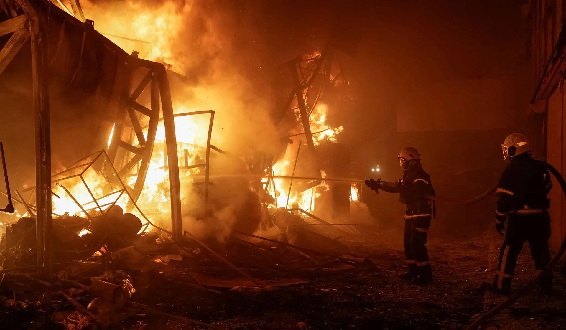 Firefighters work at the site of the Barabashovo market hit by Russian drone strike in Kharkiv