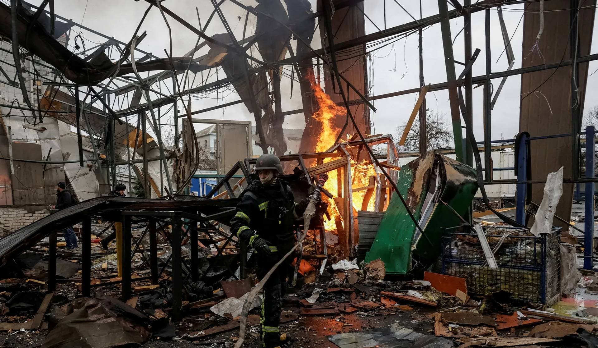 A firefighter works at the site of a Russian drone strike in Kharkiv