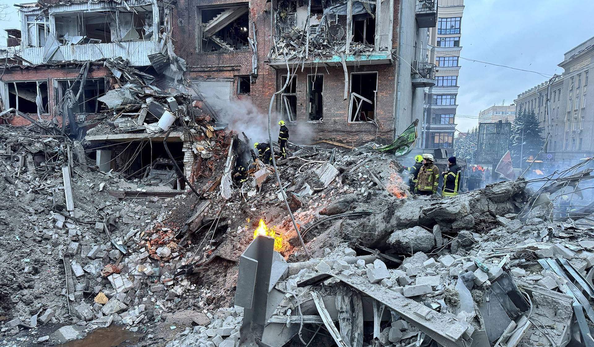Rescuers work at the site of an apartment building hit by a Russian air strike in Kharkiv