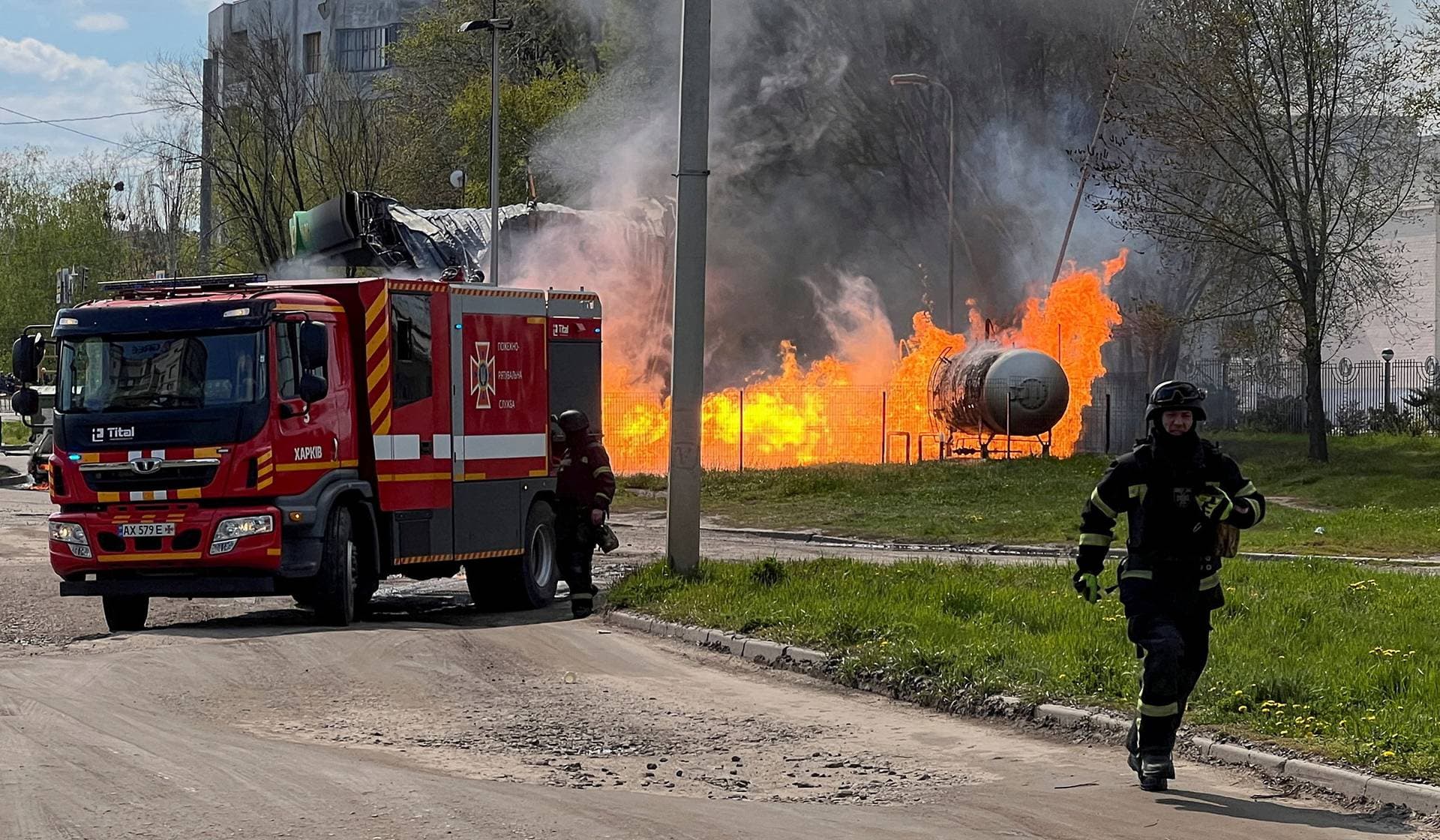 Firefighters arrive to the site of a fuel station which was hit by a Russian drone strike in Kharkiv