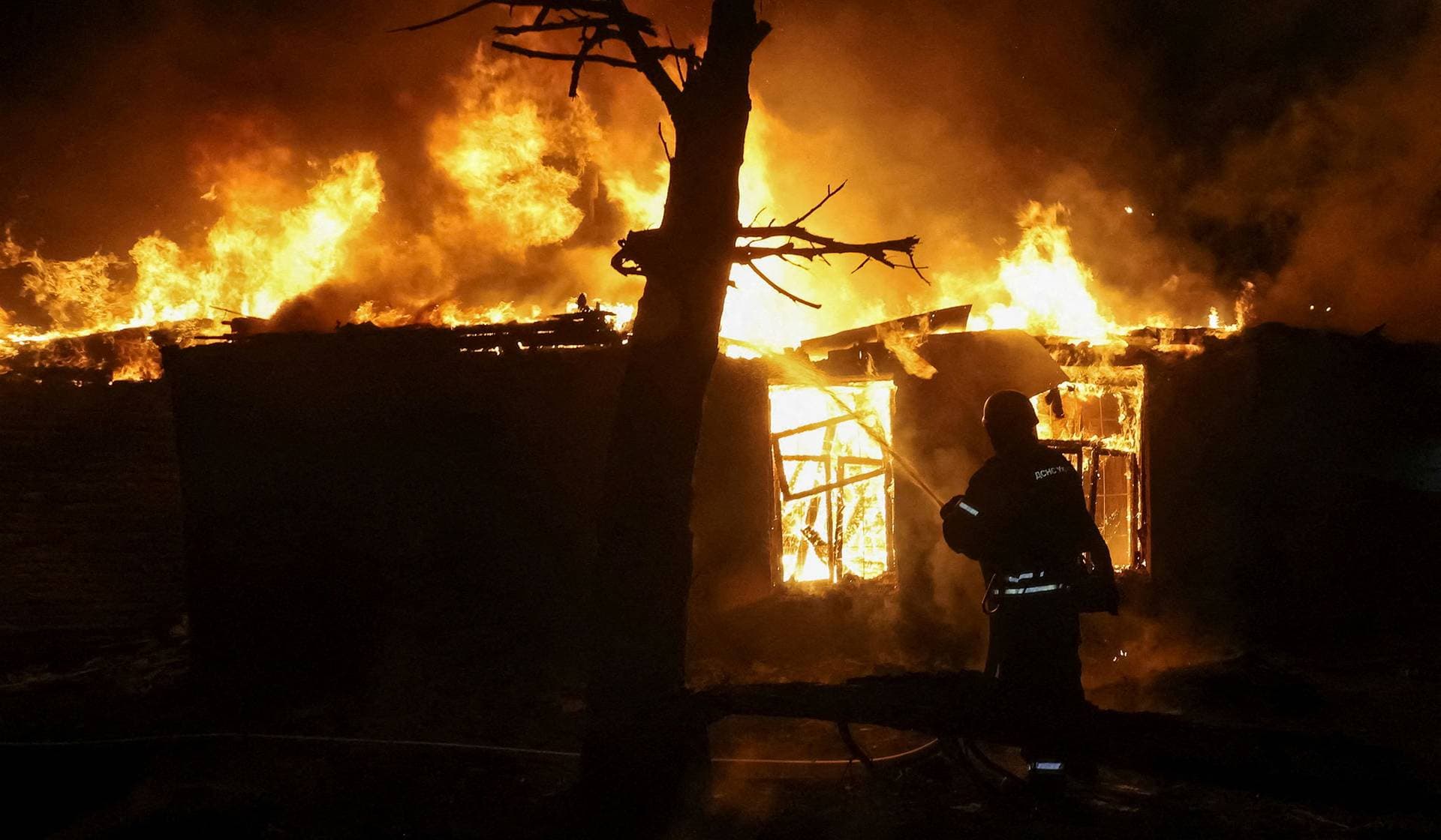 A firefighter works at the site of a Russia drone strike in Kharkiv