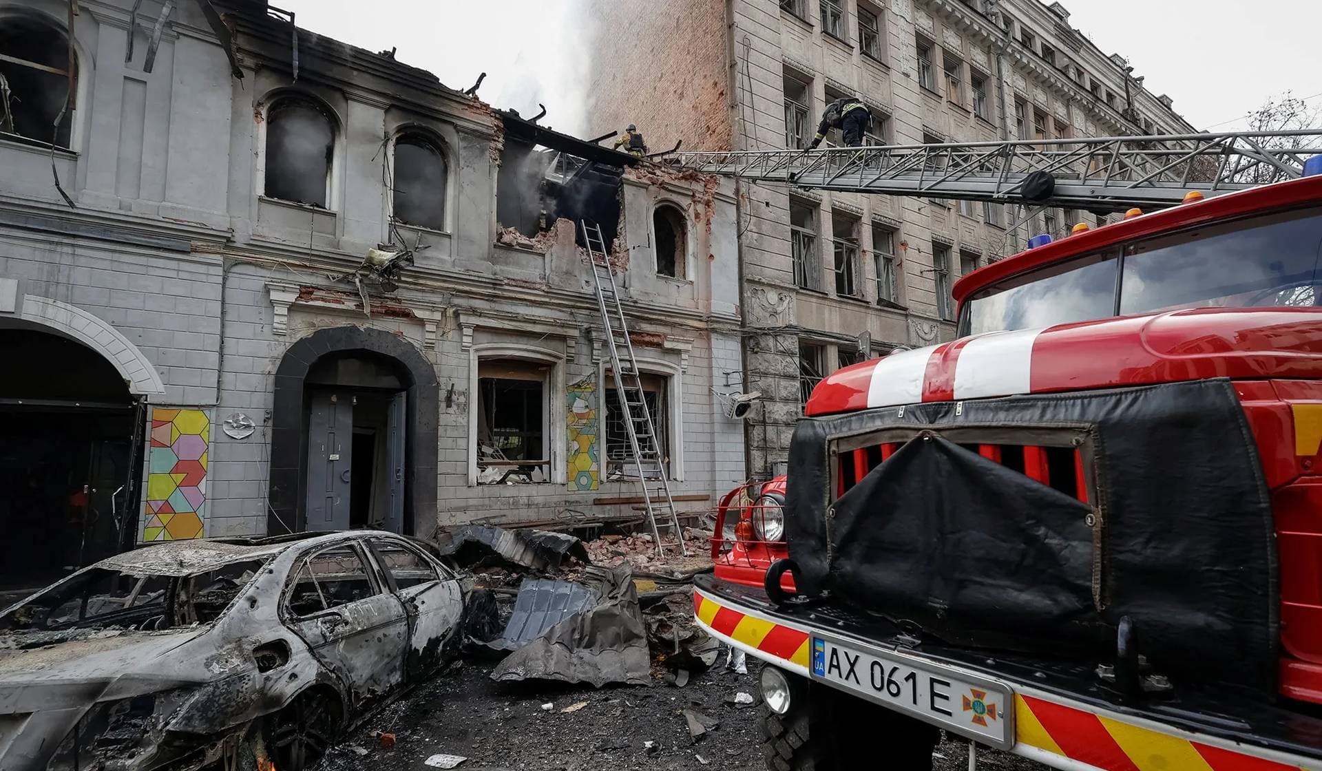 Firefighters work at the site of the kindergarten hit by Russian drone strike in Kharkiv