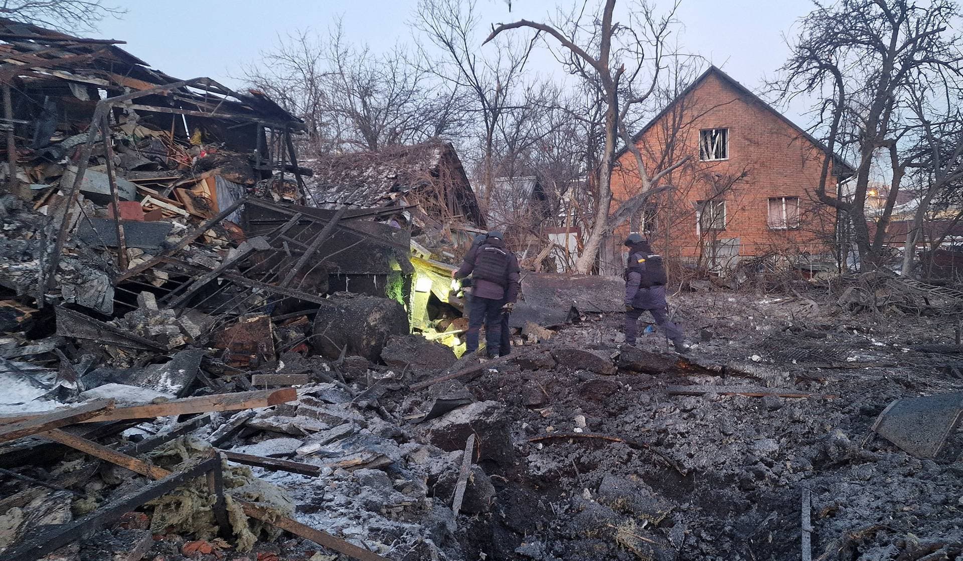 Rescuers work at the site of the Russian air strike in Kharkiv