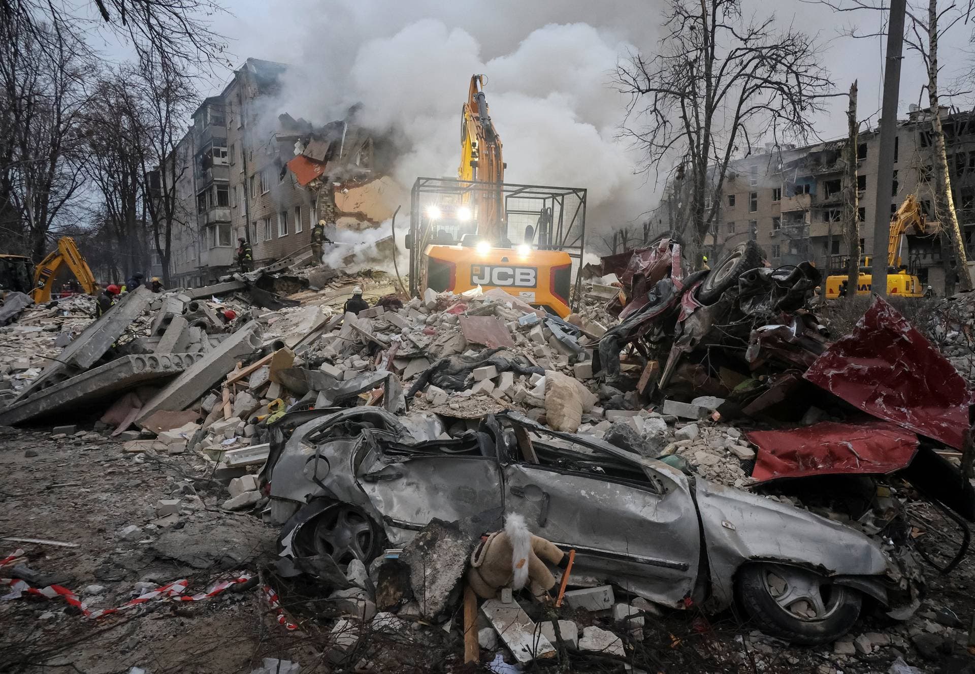 Rescuers work at the site of an apartment building hit by a Russian missile strike in Kharkiv