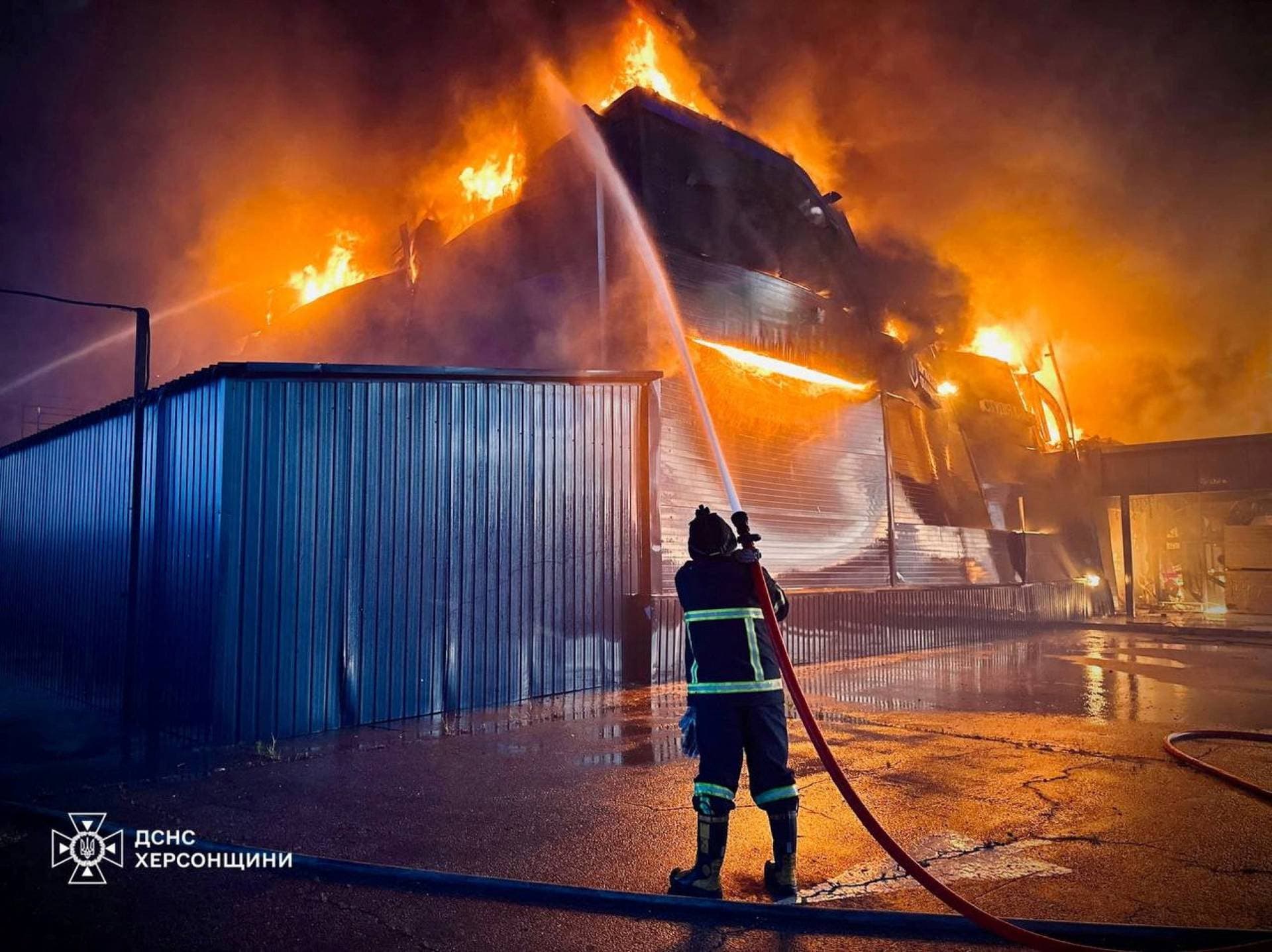 A firefighter works at the site of a household items shopping mall hit by a Russian military strike in Kherson