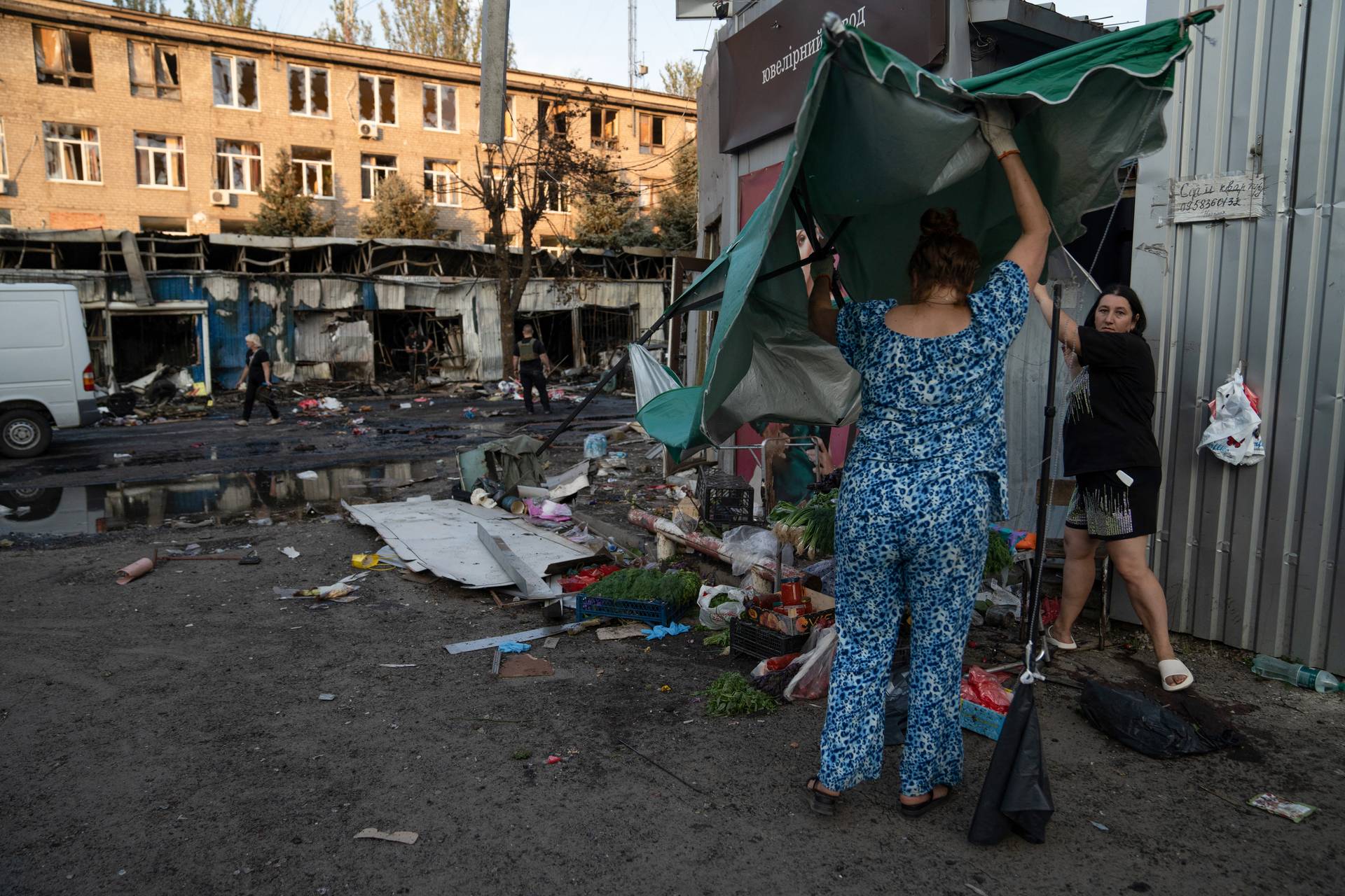 Twenty shops, power lines, an administrative building and the floor of an apartment building were damaged