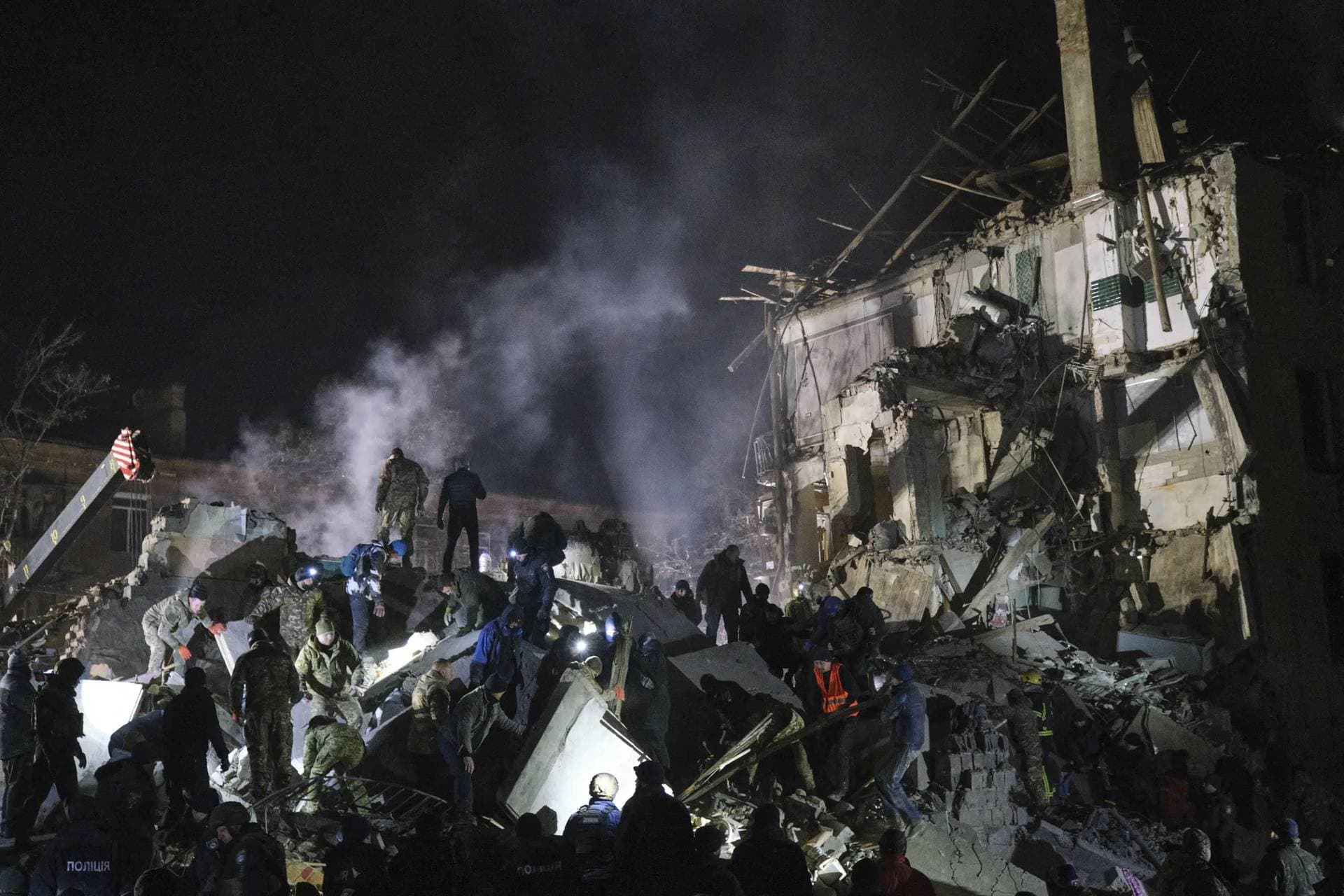 Emergency workers clear the rubble after a Russian rocket hit an apartment building in Kramatorsk