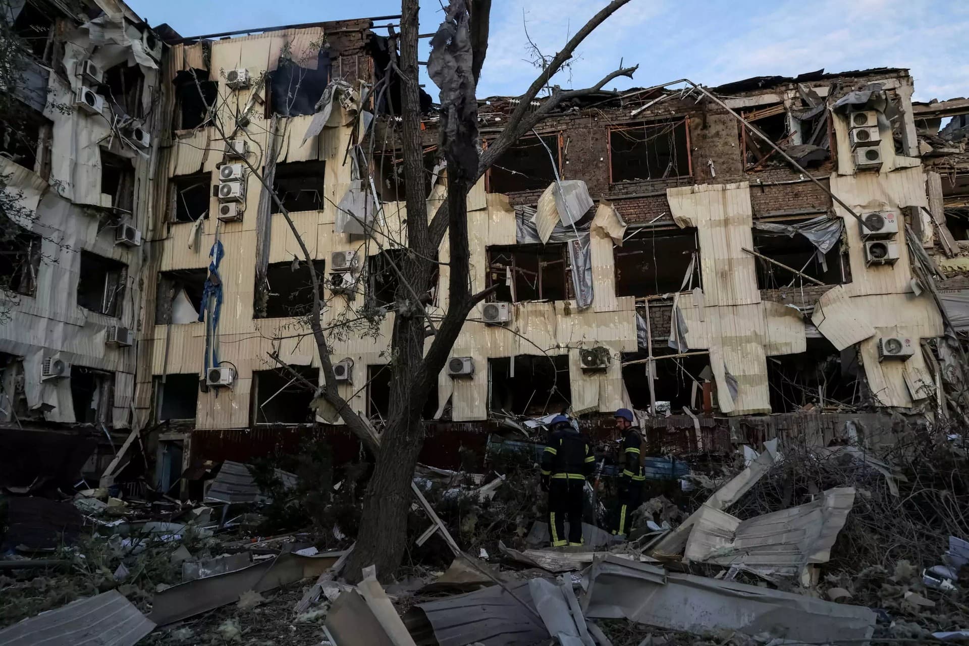 A rescuer works at the site of a building heavily damaged by the strikes