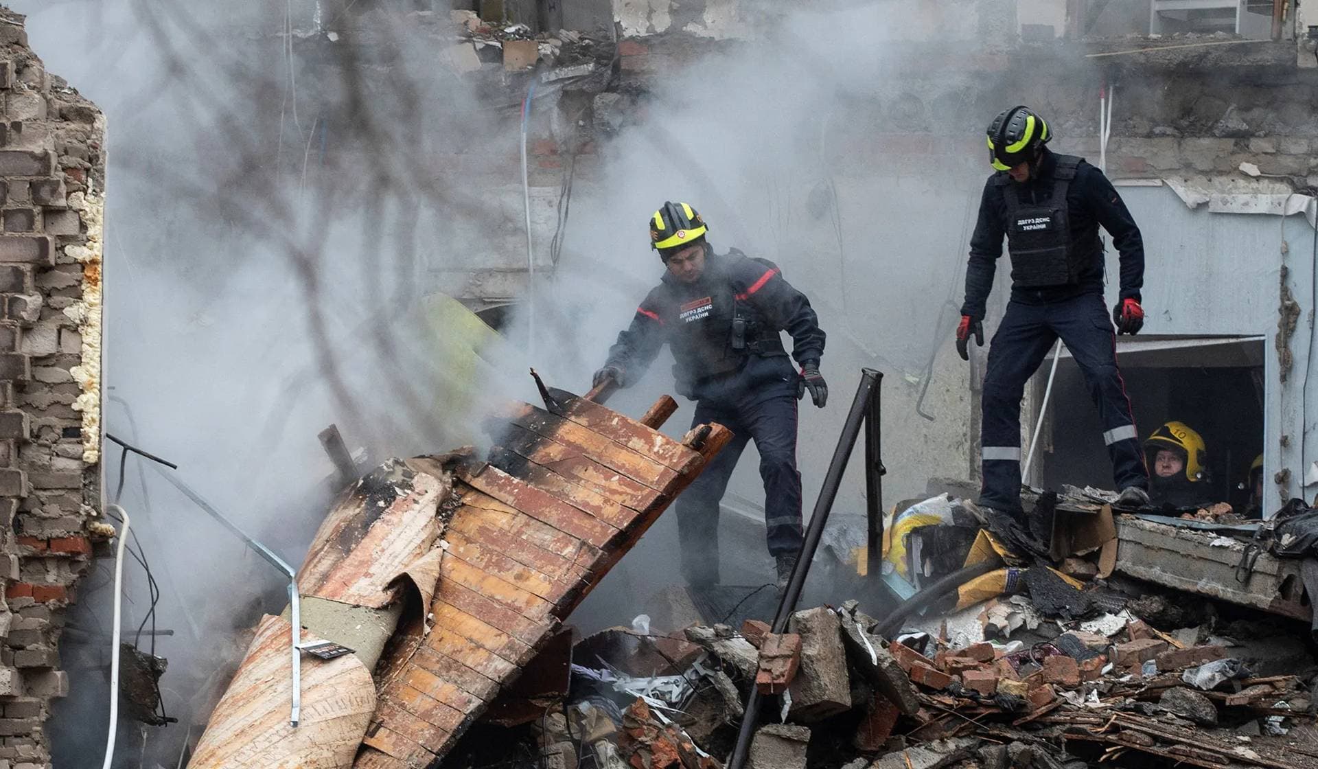 Rescuers work at the site of an apartment building hit by a Russian missile strike in Kryvyi Rih