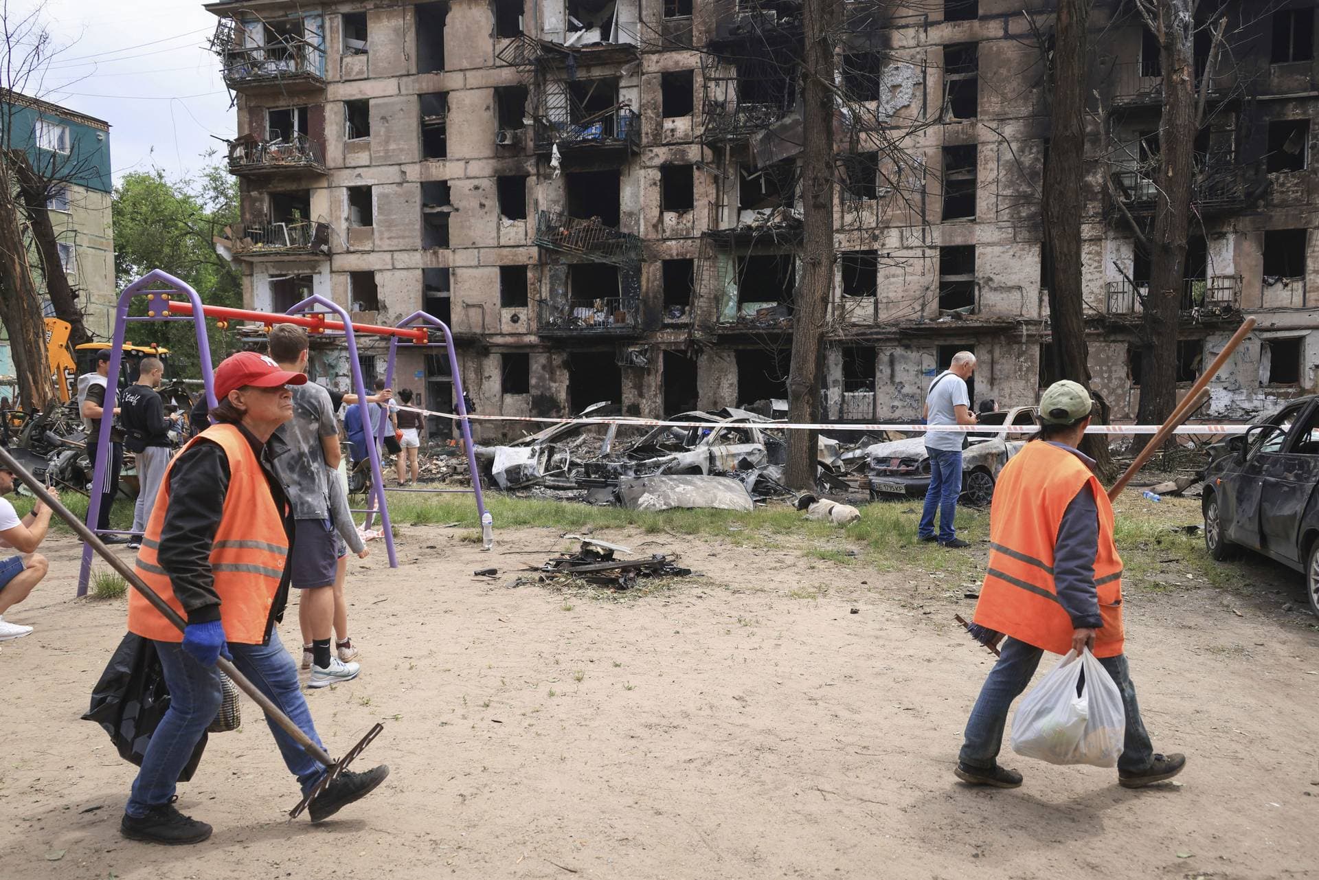 Municipal workers clean the site of the latest Russian rocket attack that damaged a multi-storey apartment building in Kryvyi Rih
