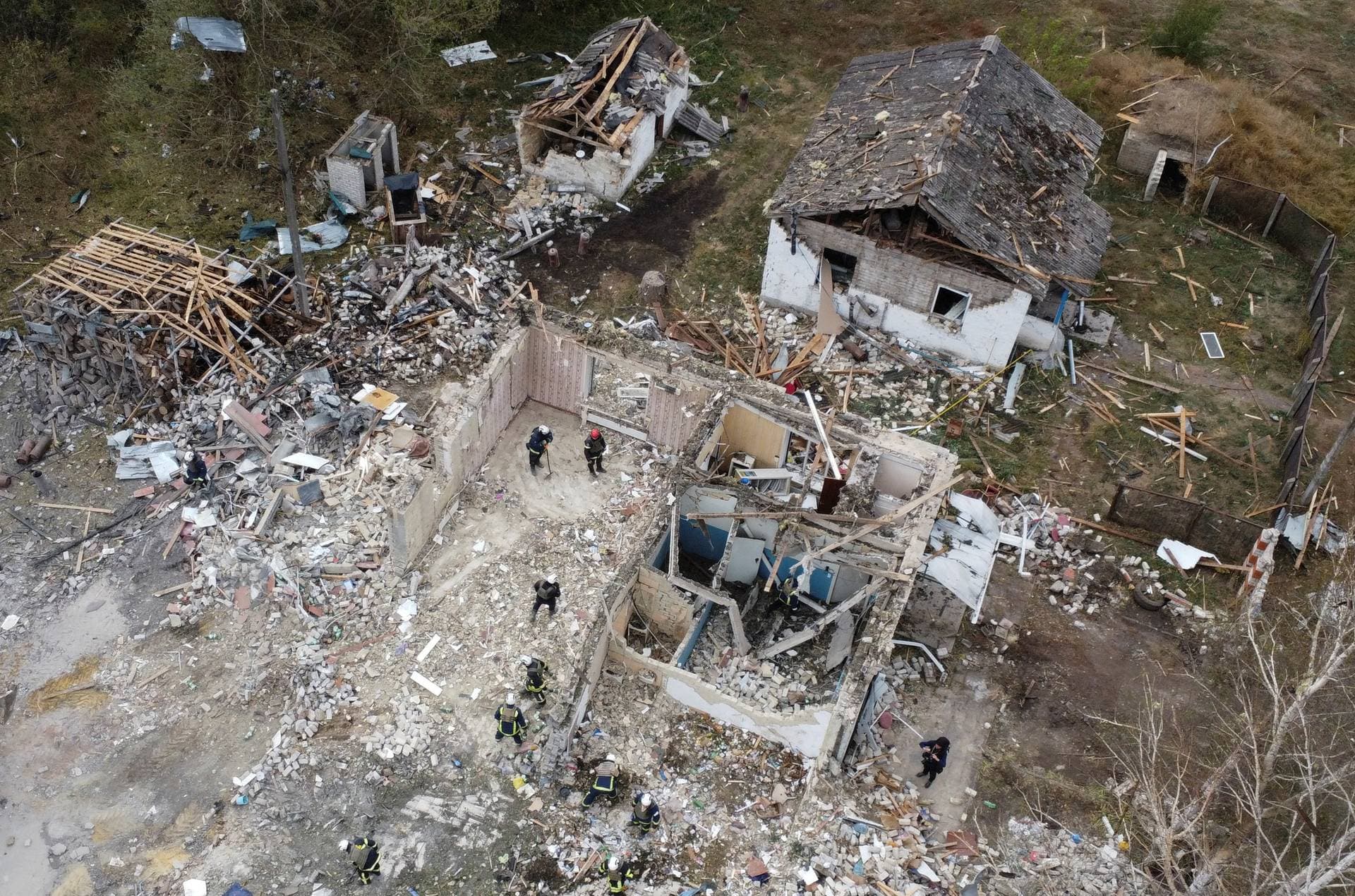 Rescues remove debris at a site of buildings of a local cafe and a grocery store in the village of Hroza
