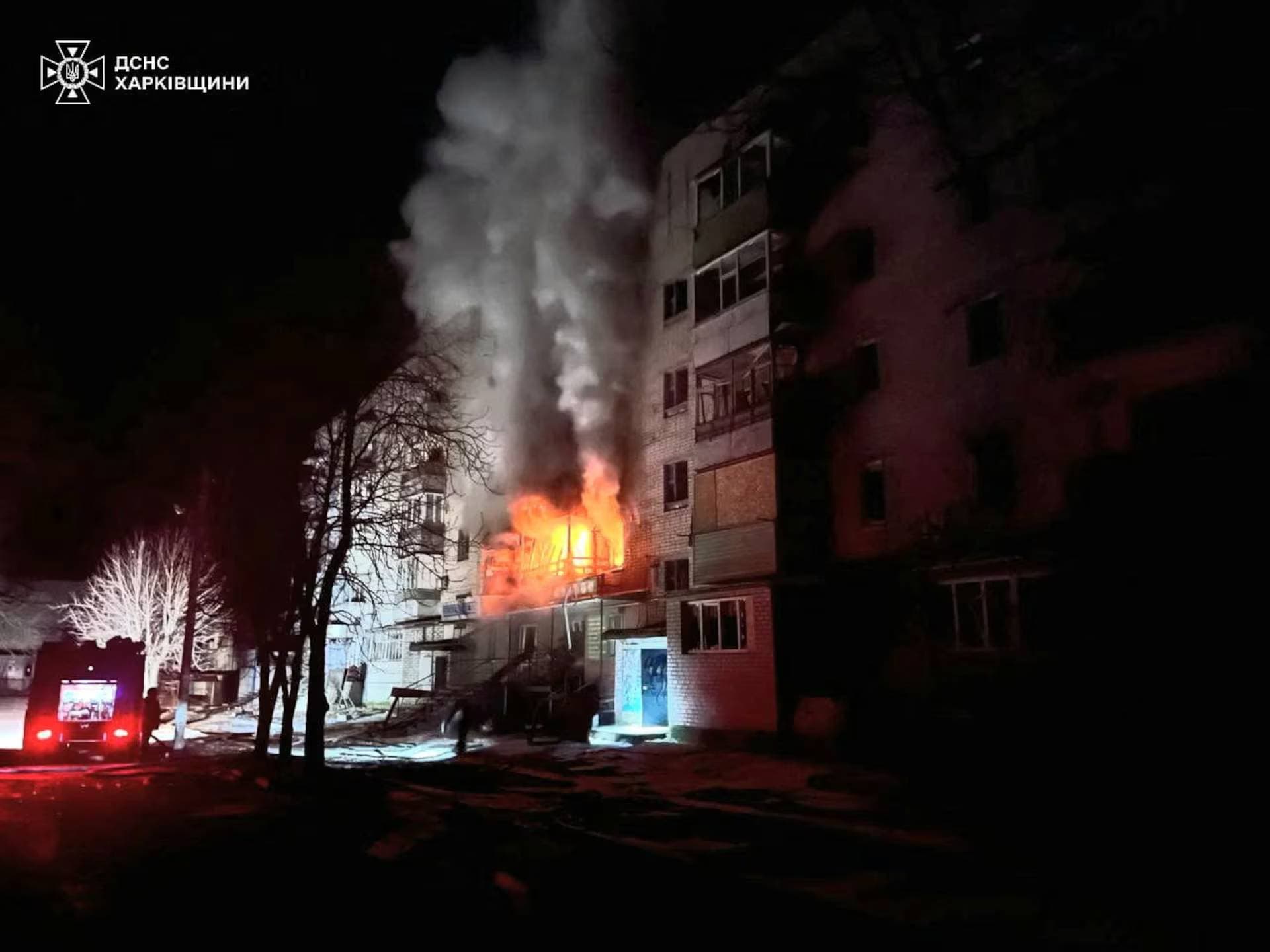 Firefighters work at a site of an apartment building damaged by a Russian air strike in the town of Kupiansk