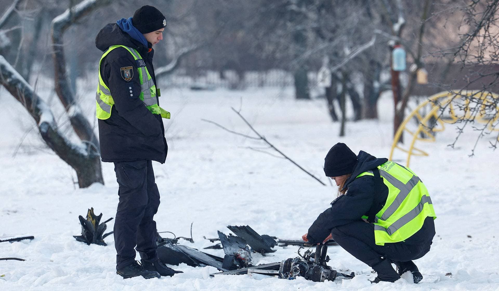 Police officers inspect remains of a Russian suicide drone in Kyiv
