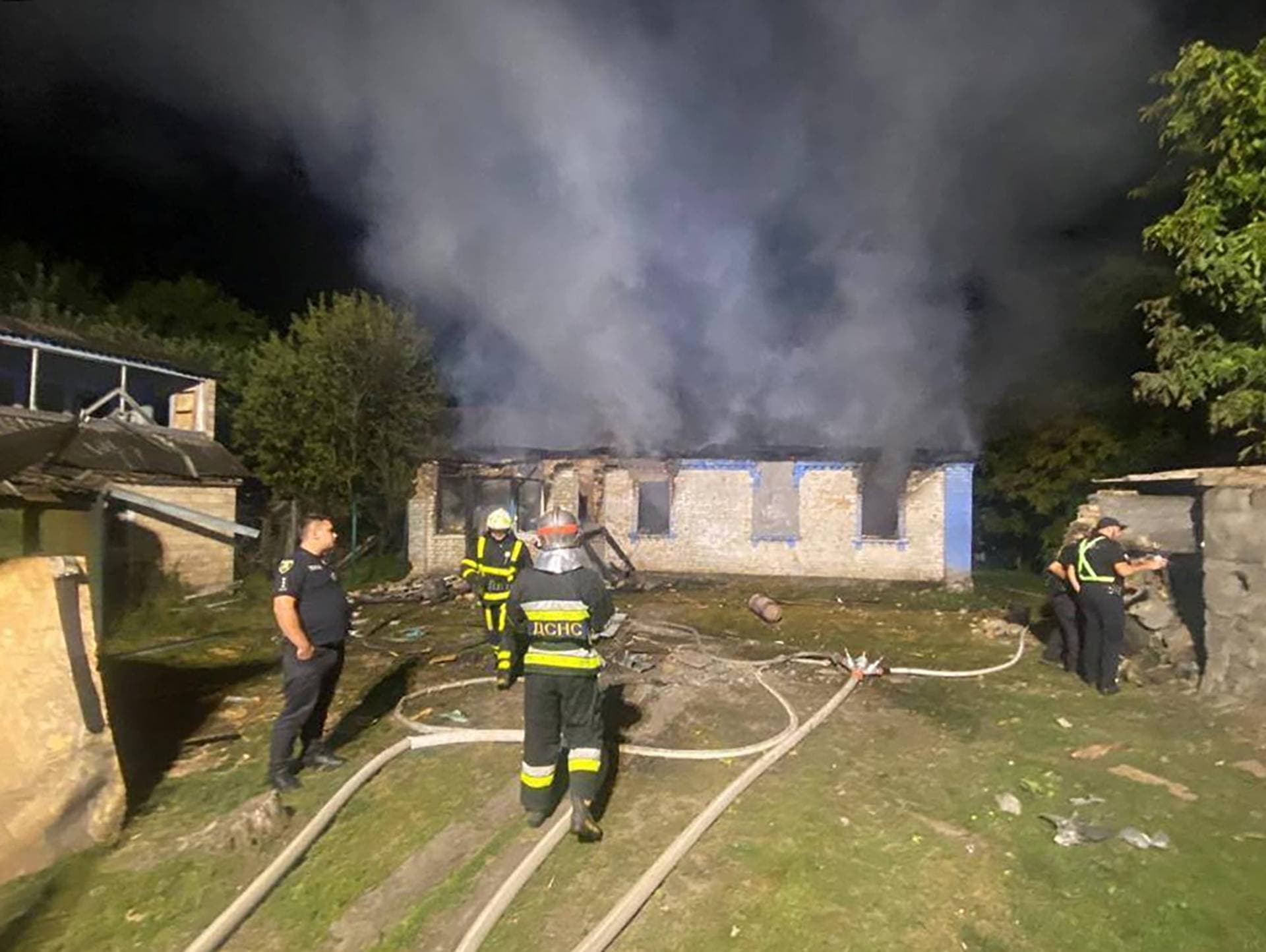 Rescuers work at a site of a residential building heavily damaged by a Russian drone and missile strikes attack in Kyiv region