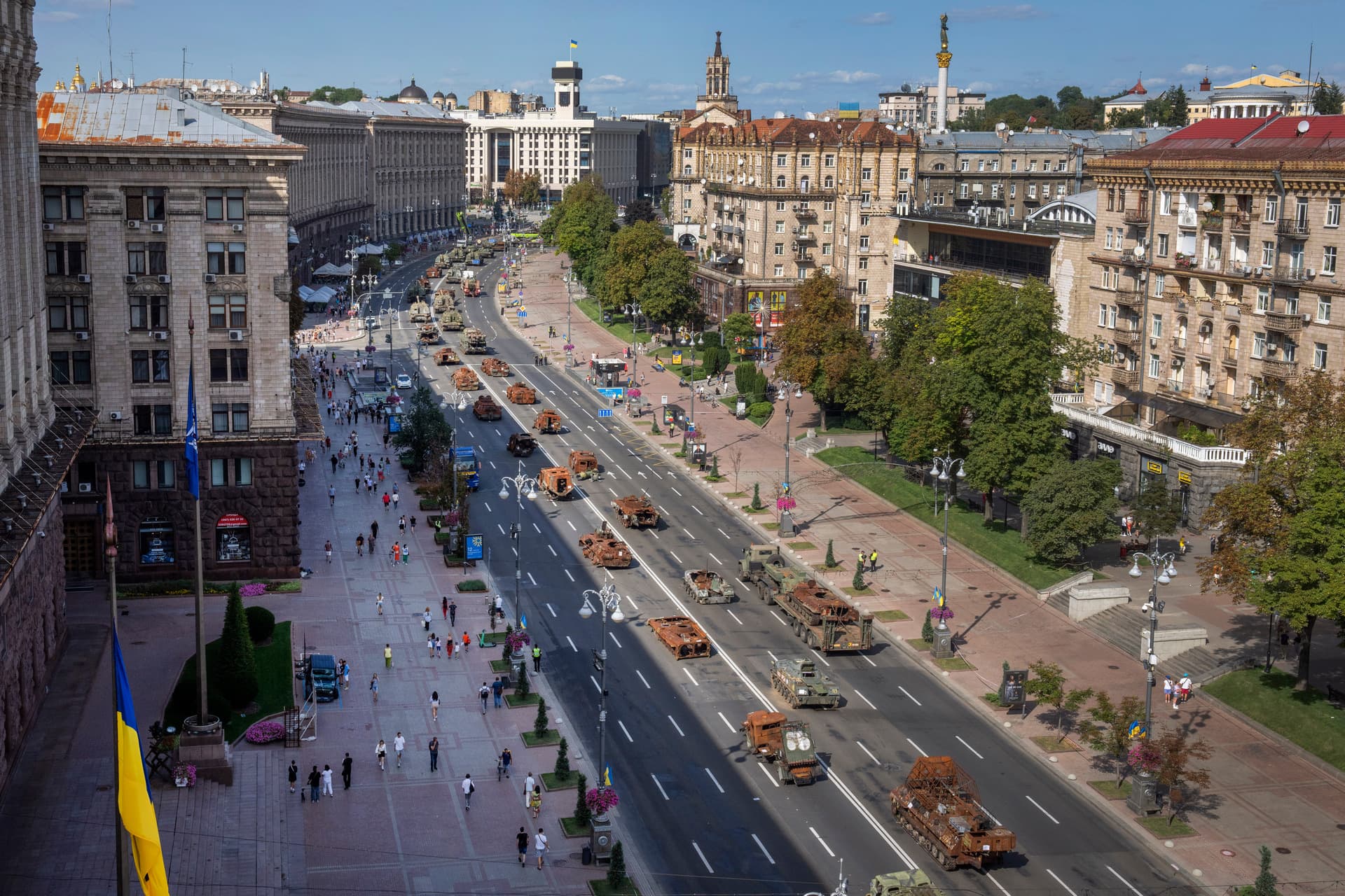 People look at a large number of burned out and captured Russian tanks and infantry carriers in Kyiv