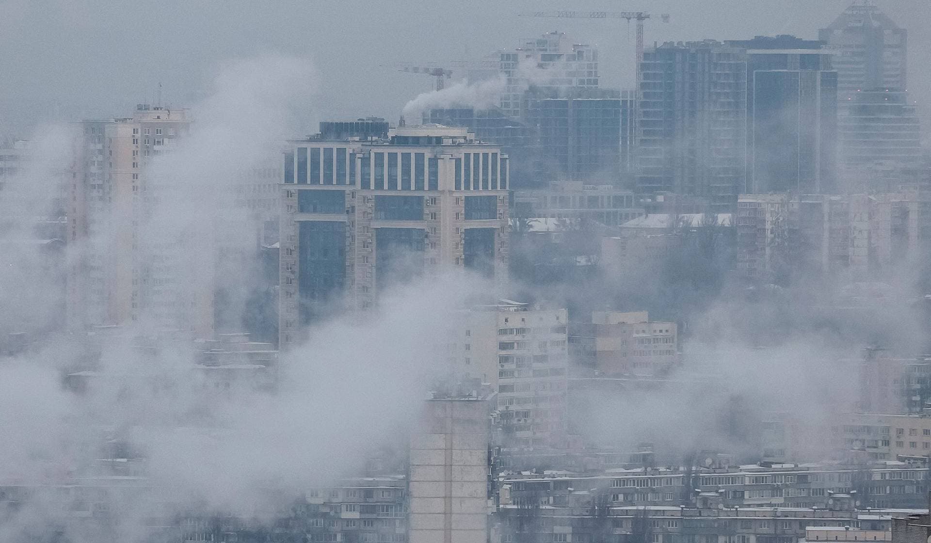 Water vapor rises from residential buildings' autonomous heating systems during a power blackout and freezing temperatures after critical civil infrastructure was hit by Russian missile and drone attacks in Kyiv