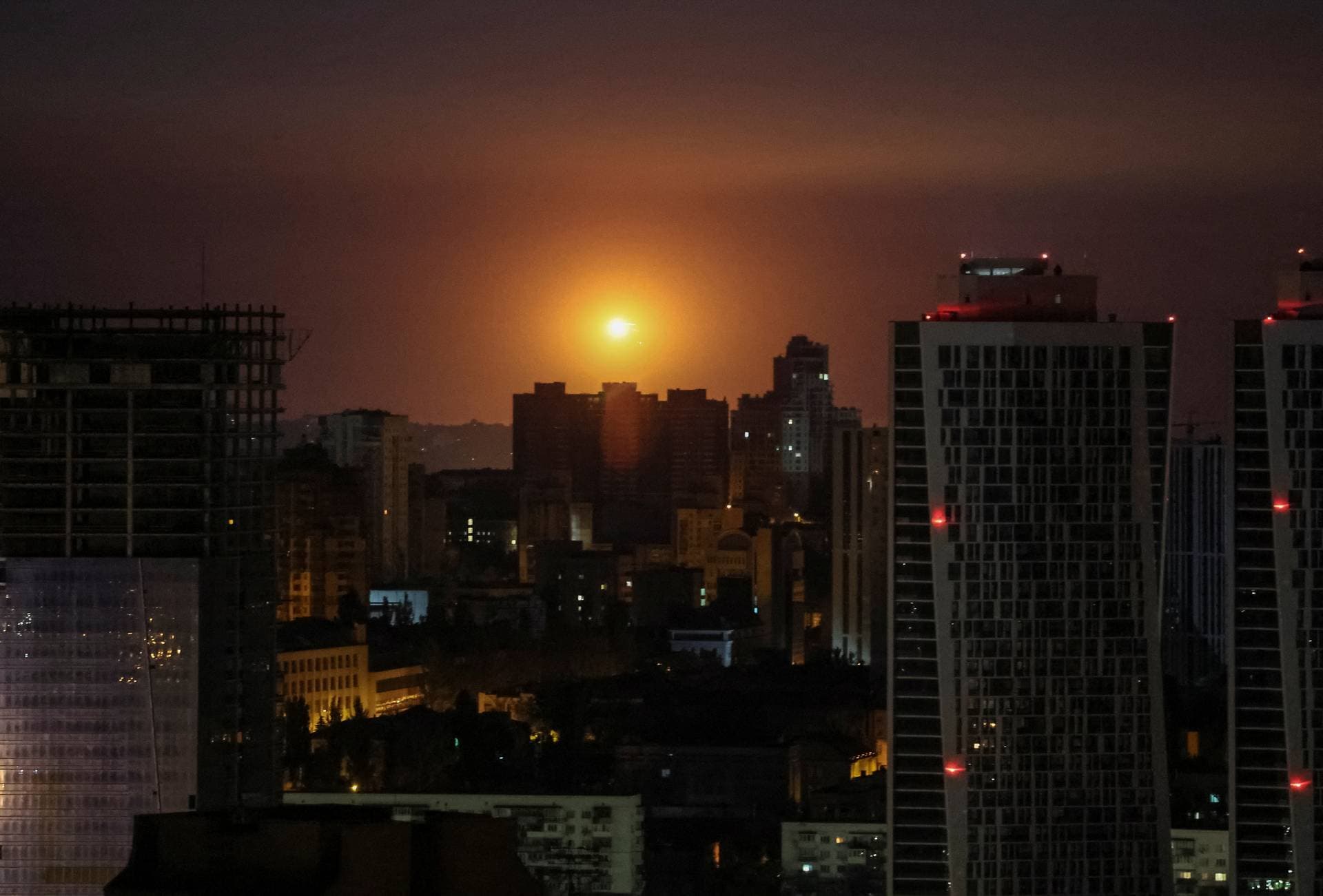 An explosion is seen in the sky over Kyiv during a Russian drone and missile attack