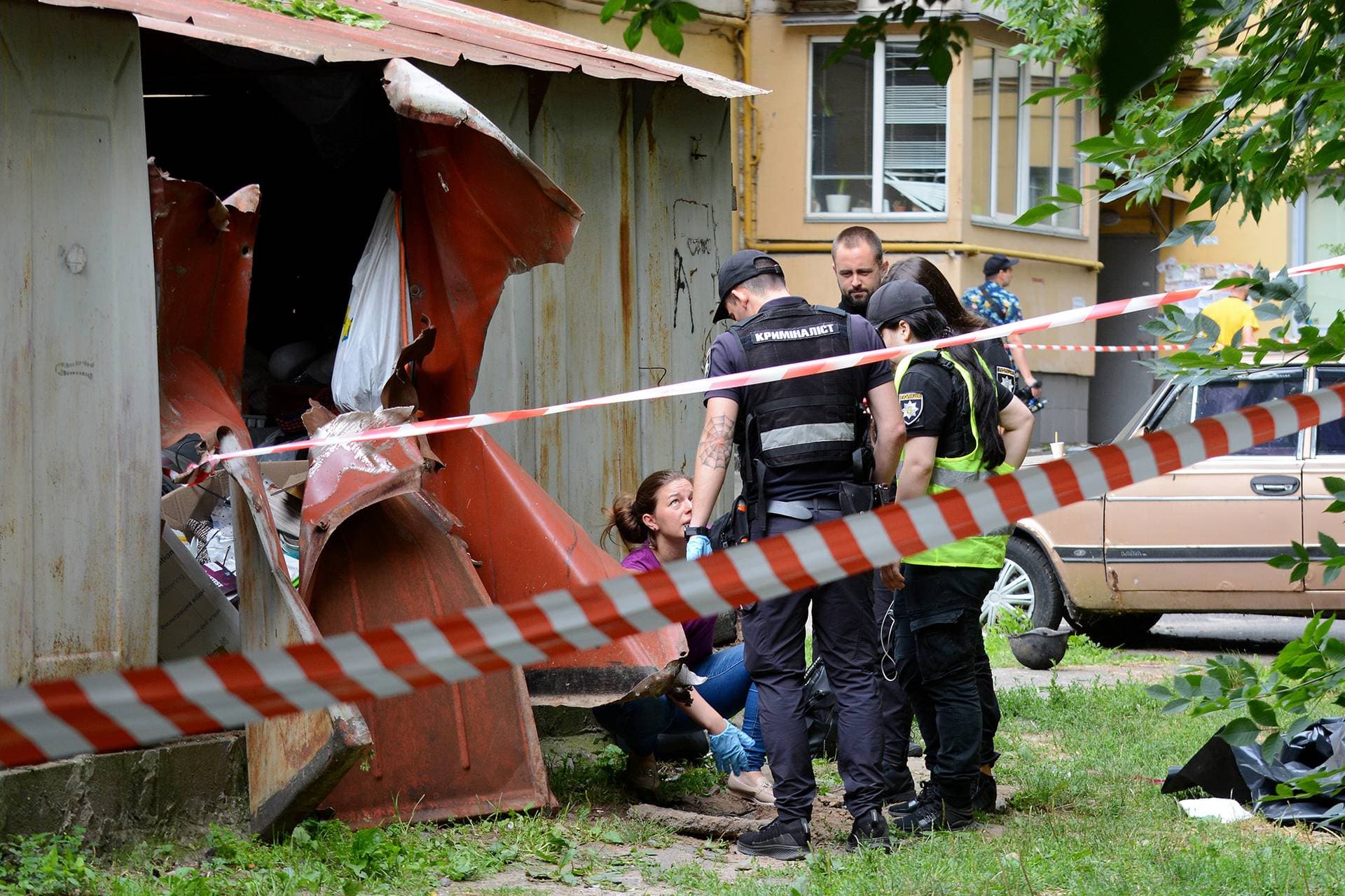 Criminologists investigate a fragment of a downed Shahed kamikaze drone that fell near a residential building in Kyiv