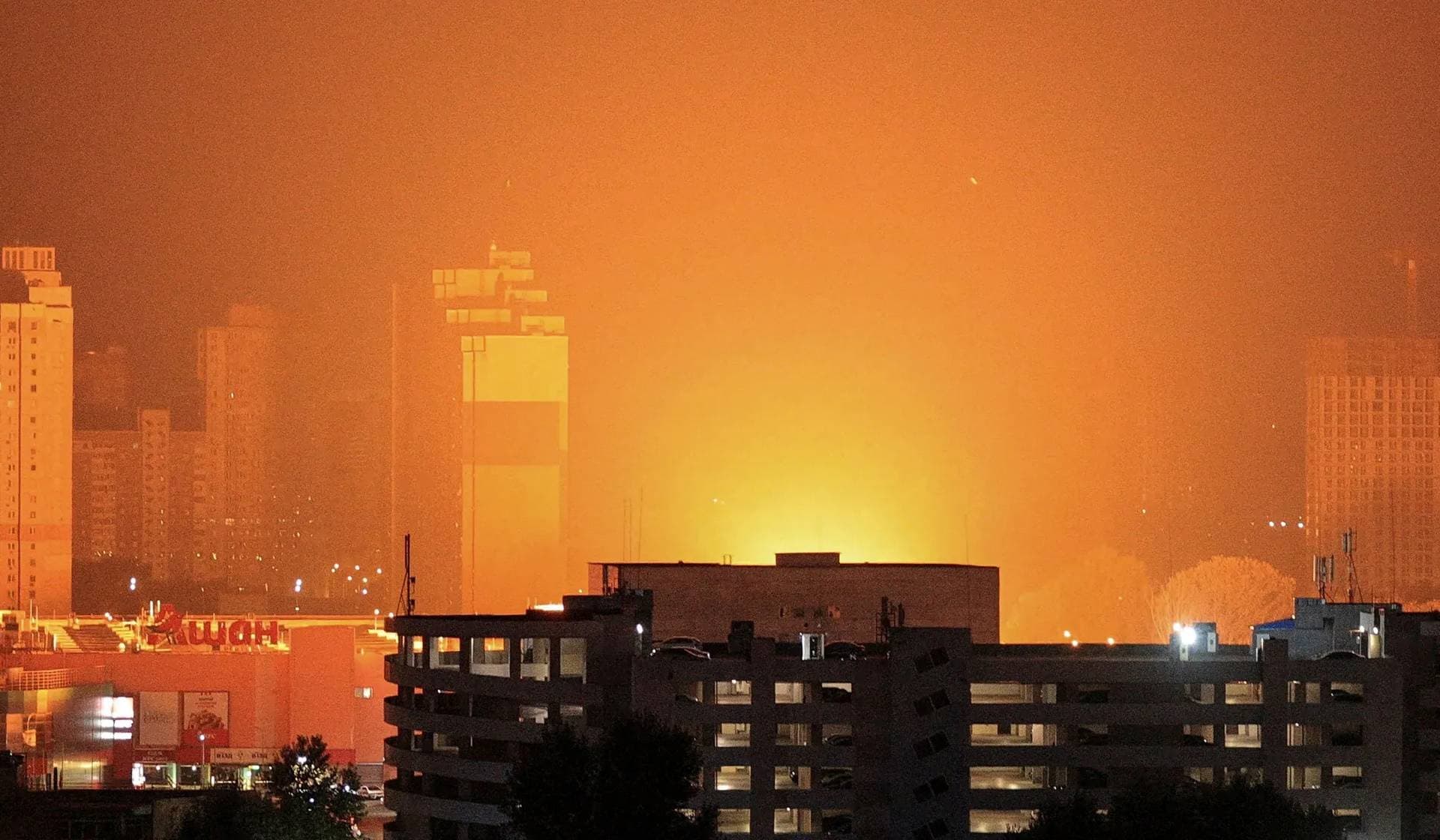 A flash from the explosion of a missile illuminates the city during a Russian missile strike in Kyiv