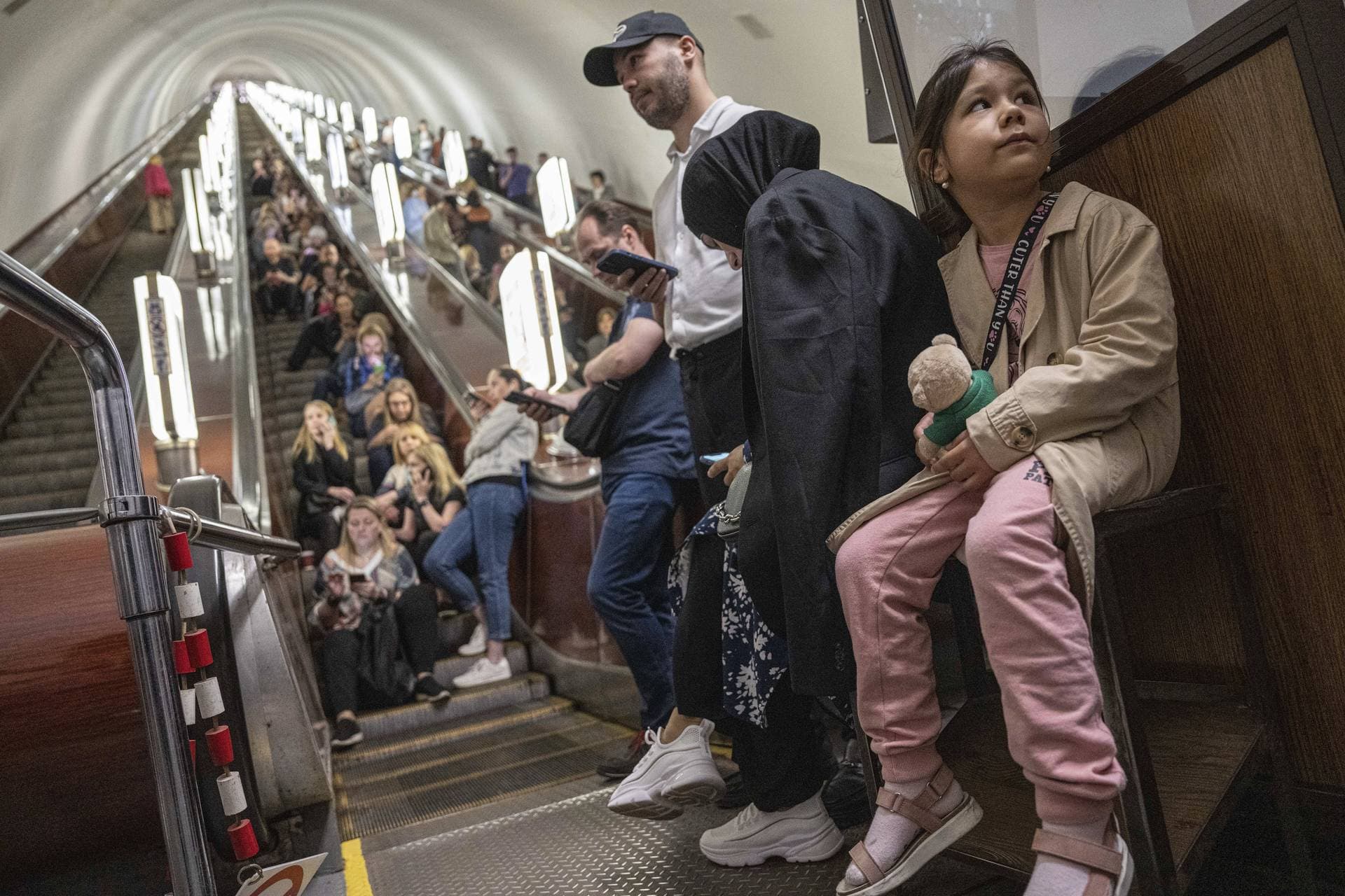 People take cover at metro station during a Russian rocket attack in Kyiv