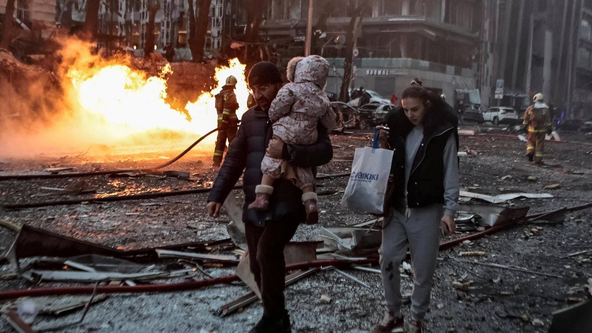 People leave the site of a Russian missile strike in Kyiv
