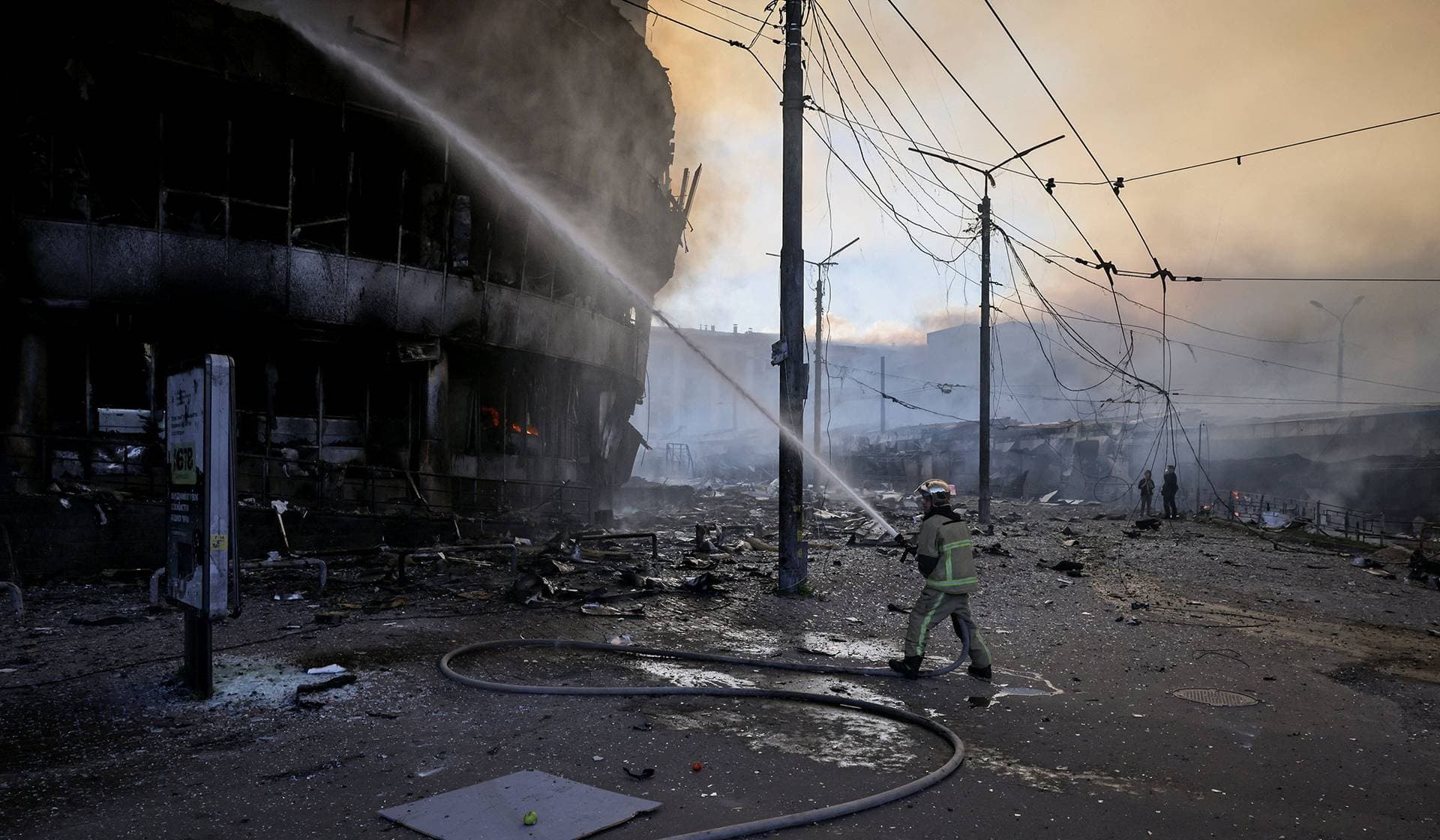 A firefighter works at the site of a damaged building in the aftermath of an overnight Russian missile and drone strike in Kyiv