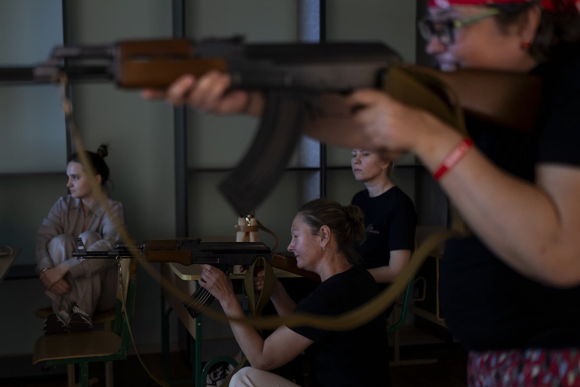 Participants takes aim with mock AK-47 rifles during firearms training for civilians amid the country’s ongoing war against Russia in Kyiv