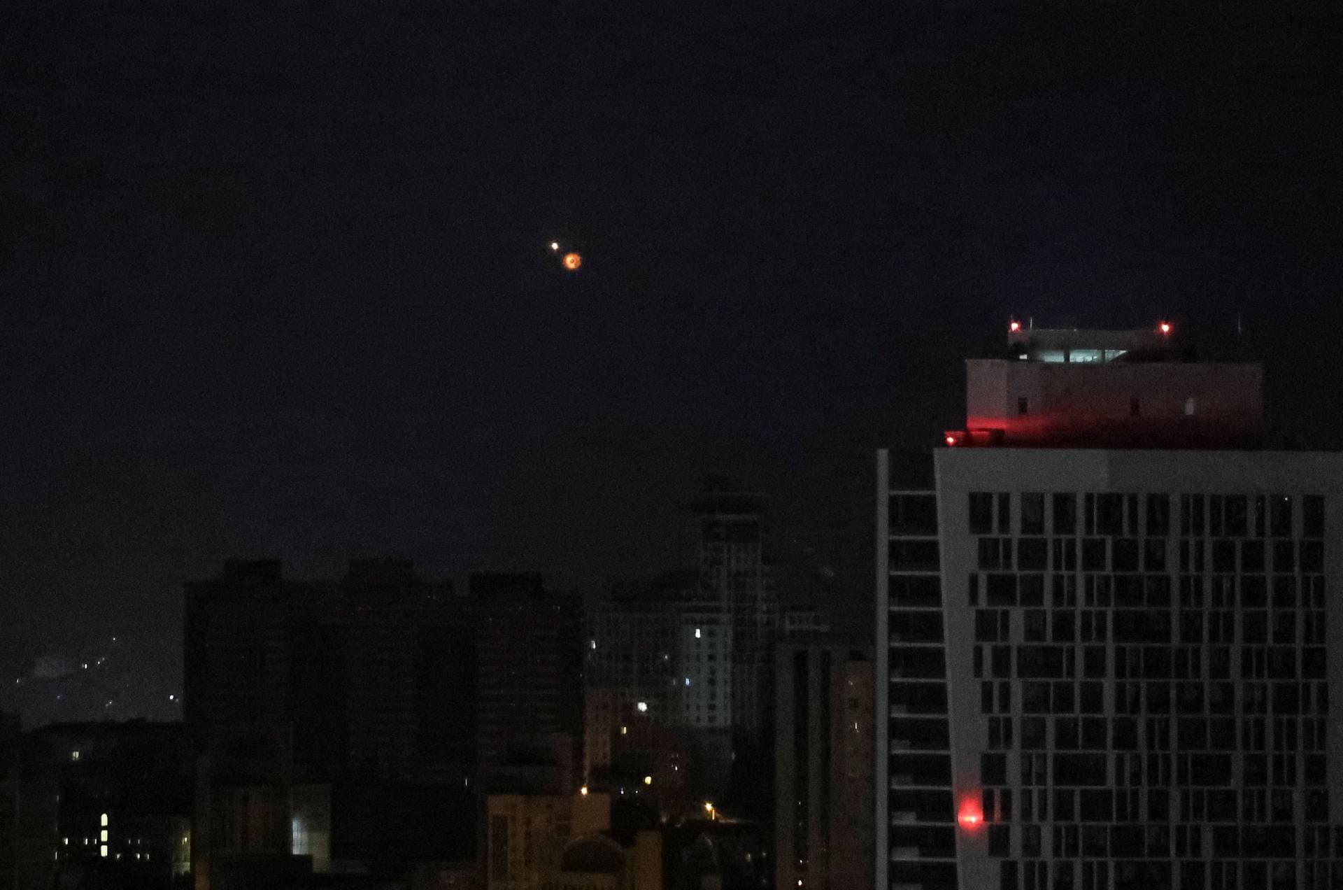 An explosion of a drone is seen in the sky over the city in Kyiv