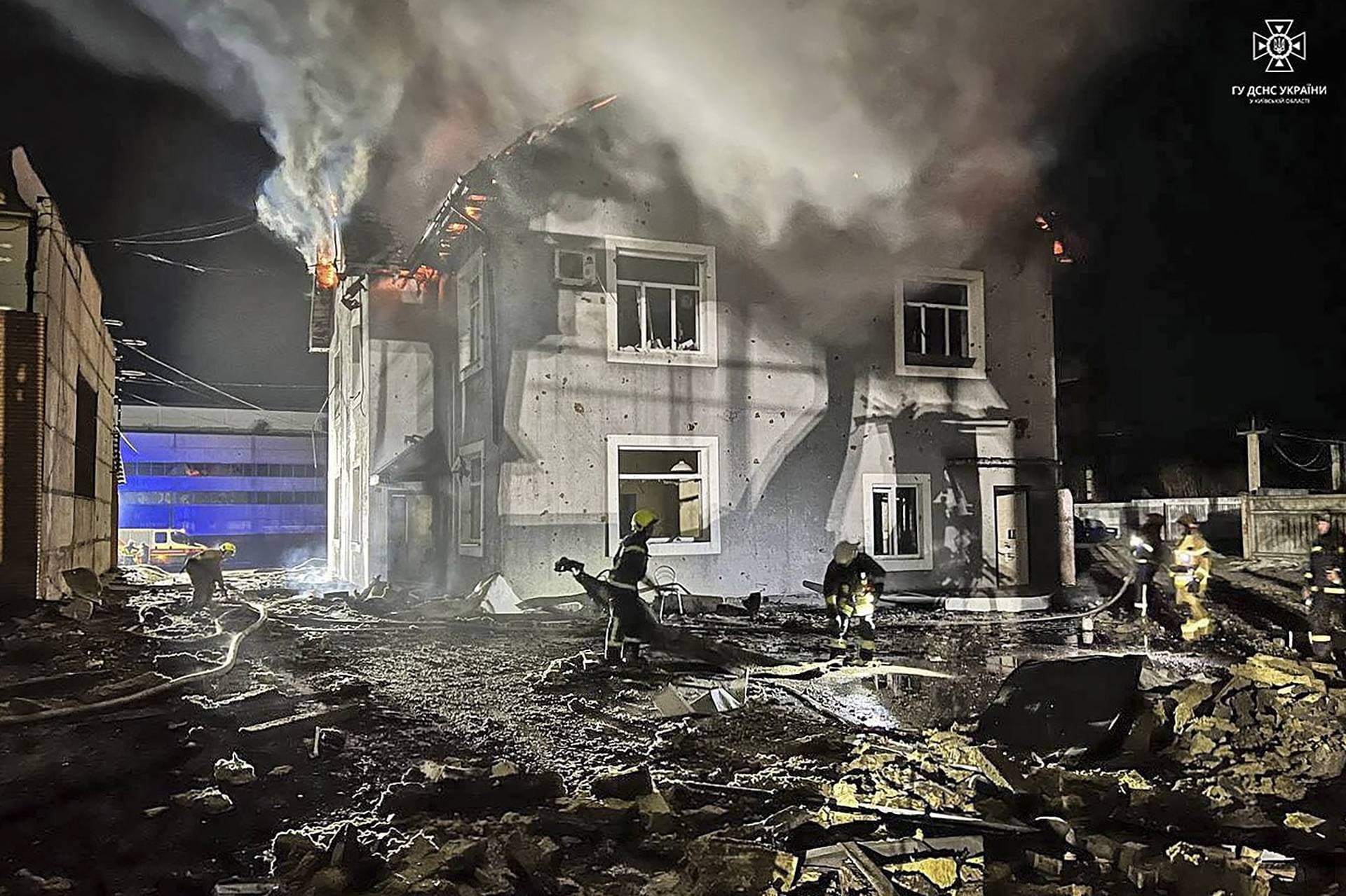 Firefighters work at a site where production facilities were damaged during a Russian drone strike in the Kyiv region