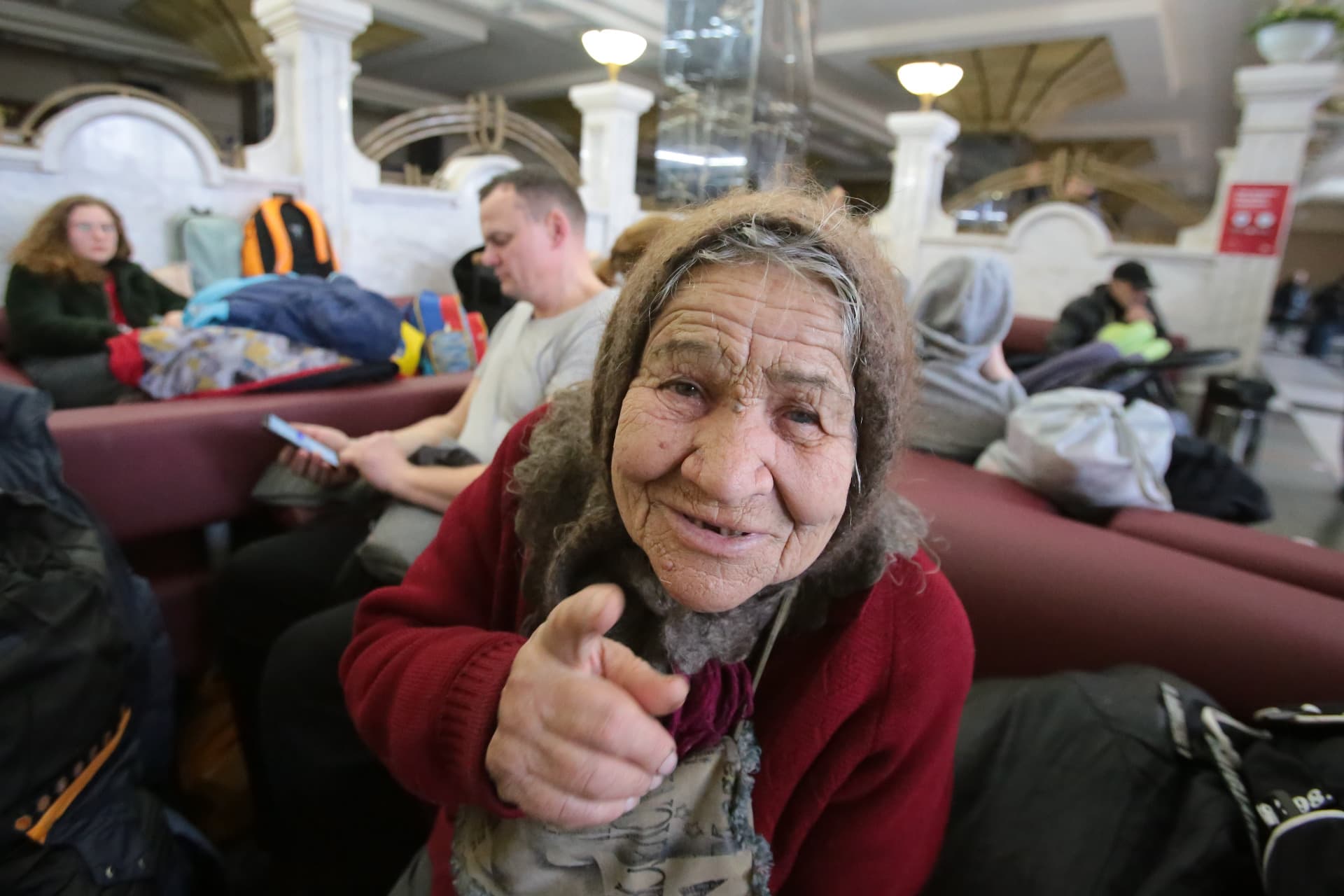 Elderly woman in the waiting room, at the railway station